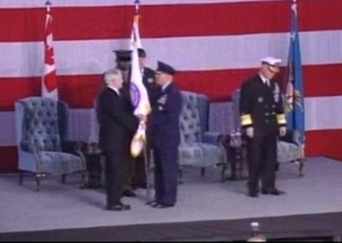 Secretary of Defense Robert Gates  hands the U.S. Northern Command flag to U.S. Air Force Gen. (sel) Victor Renuart during a change-of-command ceremony at Peterson Air Force Base, Colo., March 23, 2007. 