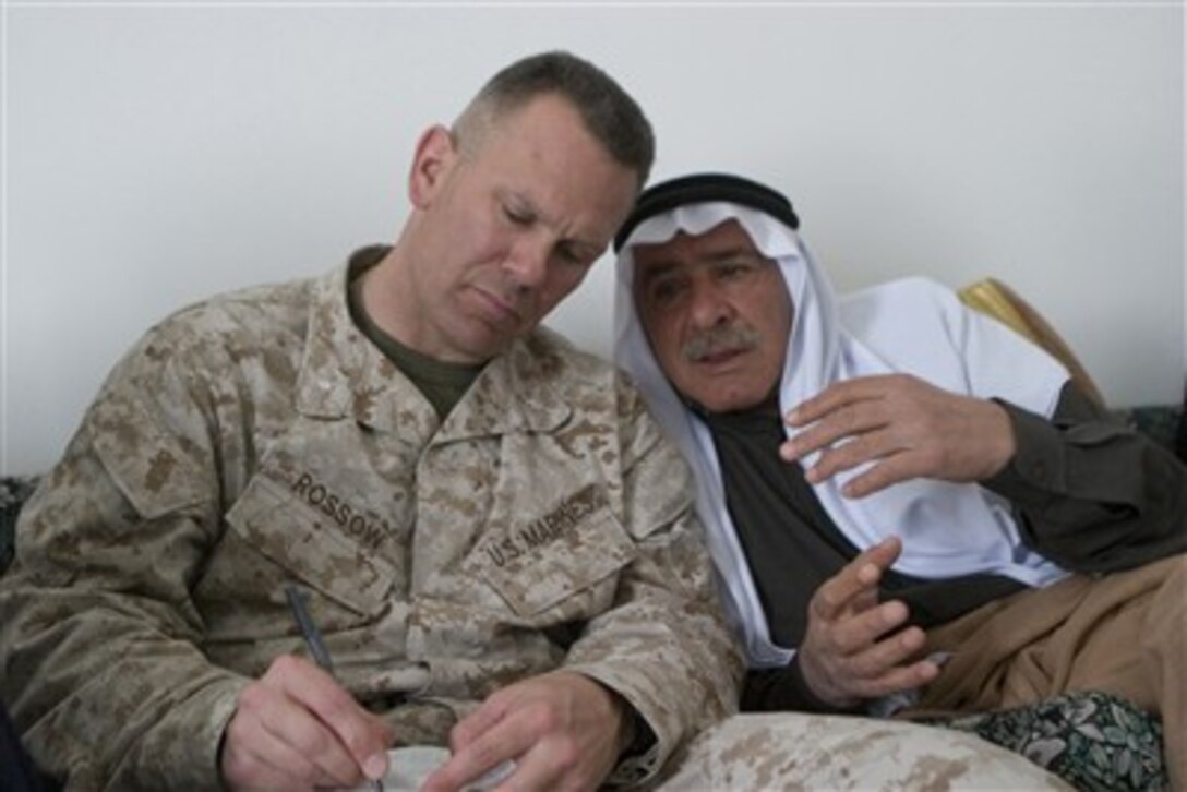 U.S. Marine Corps Lt. Col. Shane Rossow takes notes as he listens to a local sheik during a council meeting in Hit, Iraq, on March 17, 2007.  Rossow, a civil affairs group commander from 5th Battalion, 10th Marine Regiment, is meeting with local leaders to assess the need for improvements in the city.  