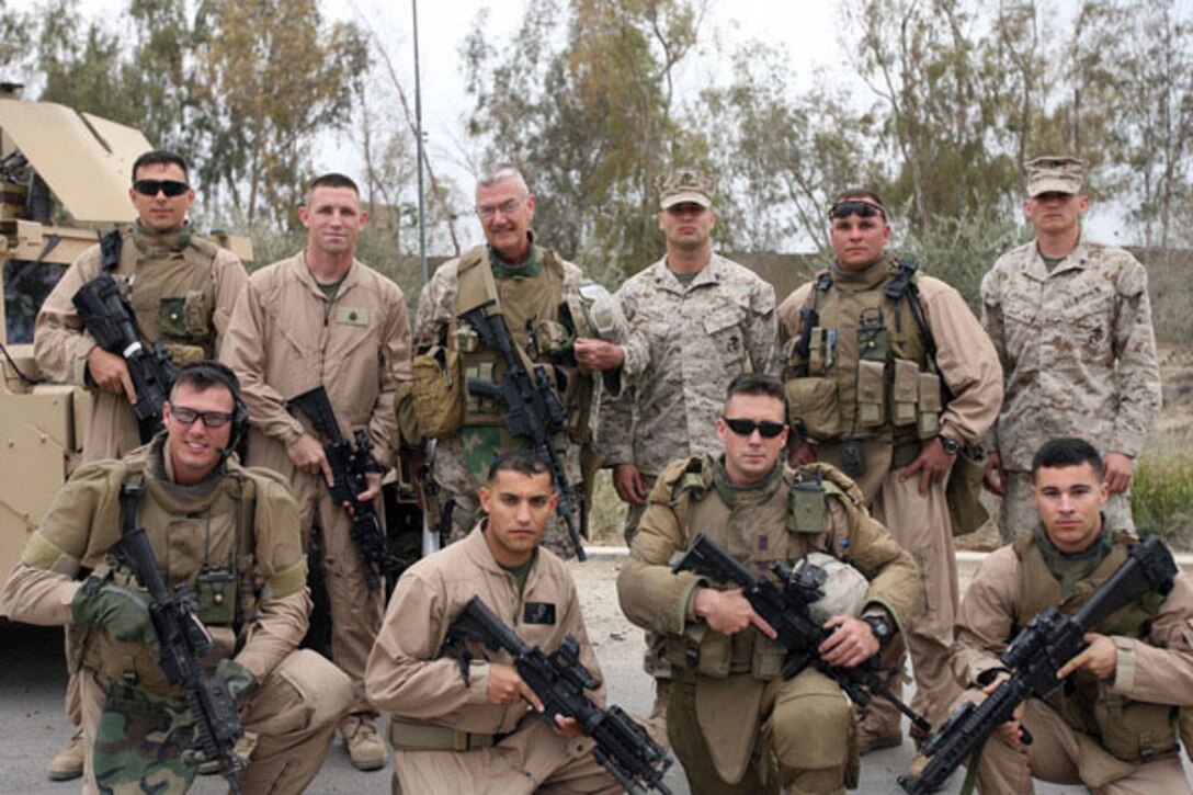 Chief Warrant Officer 5 James Roussell, a 56-year-old tactical intelligence officer from Chicago, with 1st Battalion, 24th Marine Regiment, Regimental Combat Team 6, stand with Marines who work with him in the battalion’s intelligence shop and Marines from the Personnel Security Detachment who escorts Roussell to the various meetings he attends throughout Fallujah. Roussell joined the Marine Corps in 1970 and served in Vietnam, the Gulf War and Operation Iraqi Freedom. Roussell has dedicated most of his life to keeping Americans safe both overseas and on American soil serving as a Chicago Police Officer for the last 29 years with the anti-gang tactical unit. (Official U.S. Marine Corps photo by Cpl. Stephen McGinnis)