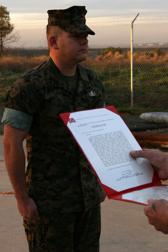 Staff Sgt. Seth L. Leonard stands at attention while his Bronze Star with combat distinguishing device citation  is read during a ceremony March 23 at the explosive  ordnance disposal facility on Camp Elliott,east of Miramar. Leonard was a EOD team leader while  deployed with Marine Wing Support Squadron 274, Marine Wing Support Group 37 (reinforced), 3rd Marine Aircraft Wing (forward), Feb. 11 to Sept. 1, 2006.