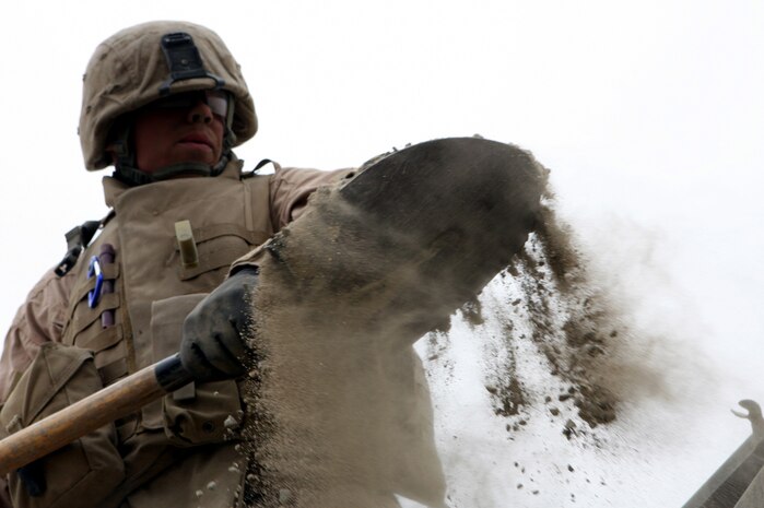 AL TAQADDUM, Iraq (March 26, 2007) ? Marines with Engineer Support Company, 8th Engineer Support Battalion, 2nd Marine Logistics Group (Forward), repair nearby roads by filling improvised explosive device craters with quick-drying concrete March 26.  ?I don?t want myself or anyone else getting blown up; plain and simple,? said Lance Cpl. Patricia Lusk, a heavy equipment operator with the company.