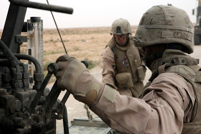 AL TAQADDUM, Iraq (March 26, 2007) ? Marines with Engineer Support Company, 8th Engineer Support Battalion, 2nd Marine Logistics Group (Forward), operate a mobile concrete mixer while on a route repair mission near here March 26.