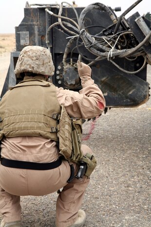 AL TAQADDUM, Iraq (March 26, 2007) ? A Marine with Engineer Support Company, 8th Engineer Support Battalion, 2nd Marine Logistics Group (Forward), ground guides a mobile concrete mixer while on a route repair mission near here March 26.