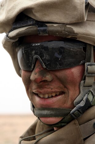 AL TAQADDUM, Iraq (March 26, 2007) ? A Marine with Engineer Support Company, 8th Engineer Support Battalion, 2nd Marine Logistics Group (Forward), musters a smile through his concrete-blotched face and poses for a photo near Al Taqaddum March 26.  The Marines of 8th ESB repaired roads within the area of operations for the safety of coalition and Iraqi forces.