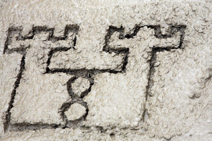 AL TAQADDUM, Iraq (March 26, 2007) ? The Marines of Engineer Support Company, 8th Engineer Support Battalion, 2nd Marine Logistics Group (Forward), call it a day and leave their mark on recently laid concrete, March 26.  The Marines went on a route repair mission in which they filled craters to safeguard coalition and Iraqi forces.
