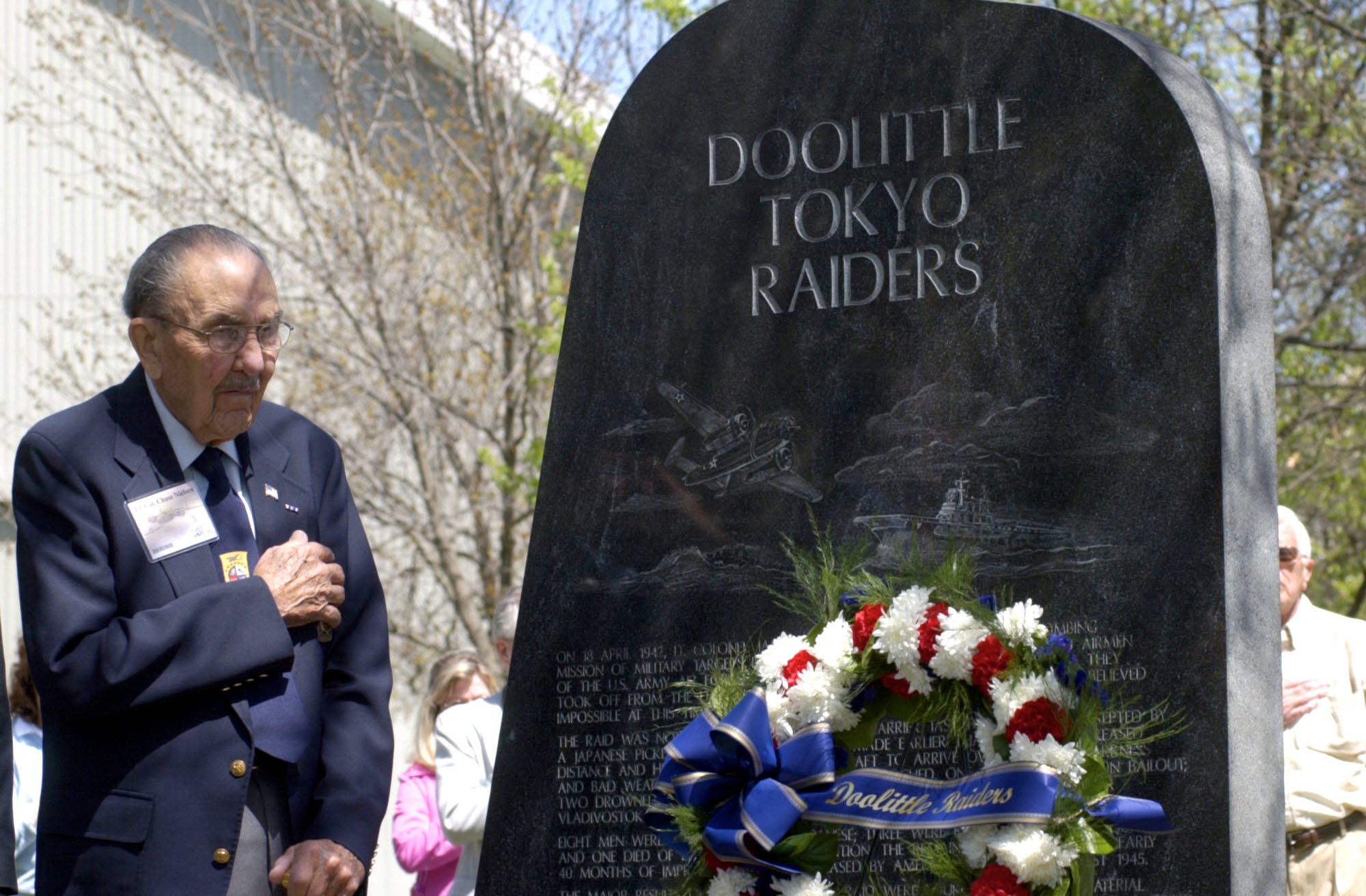 Lt. Col. (Ret.) Chase Nielsen stands for the playing of taps after a wreath was placed near the Doolittle Tokyo Raiders memorial at the National Museum of the U. S. Air Force, DAYTON, Ohio, April 18, 2006. The ceremony was held to recognize the achievements of the Raiders on the 64th anniversary of the mission over Tokyo, Japan. (U.S. Air Force photo)