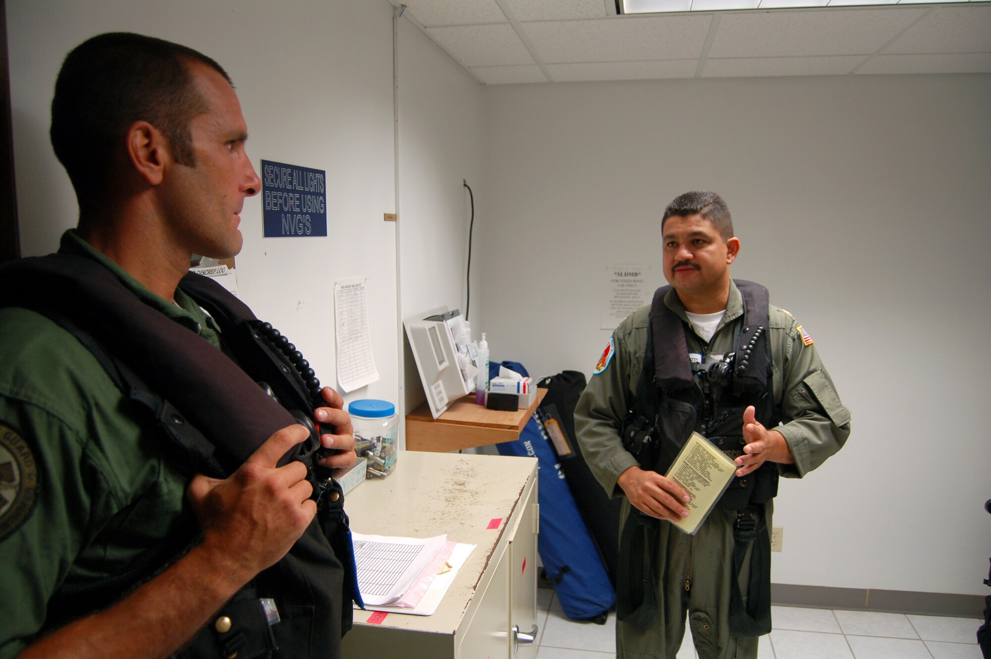 Coast Guard Lt. Cmdr. Juan Lopez (right) briefs his aircrew prior to flying an HH-65C Dolphin March 21 from Coast Guard Air Station Borinquen, Puerto Rico. A former Senior Airman, Commander Lopez is an aircraft commander and the assistant operations officer at the air station. The Coast Guard provides a search and rescue capability for 1.2 million square miles around the Caribbean. (U.S. Air Force photo/Tech. Sgt. Ben Gonzales)