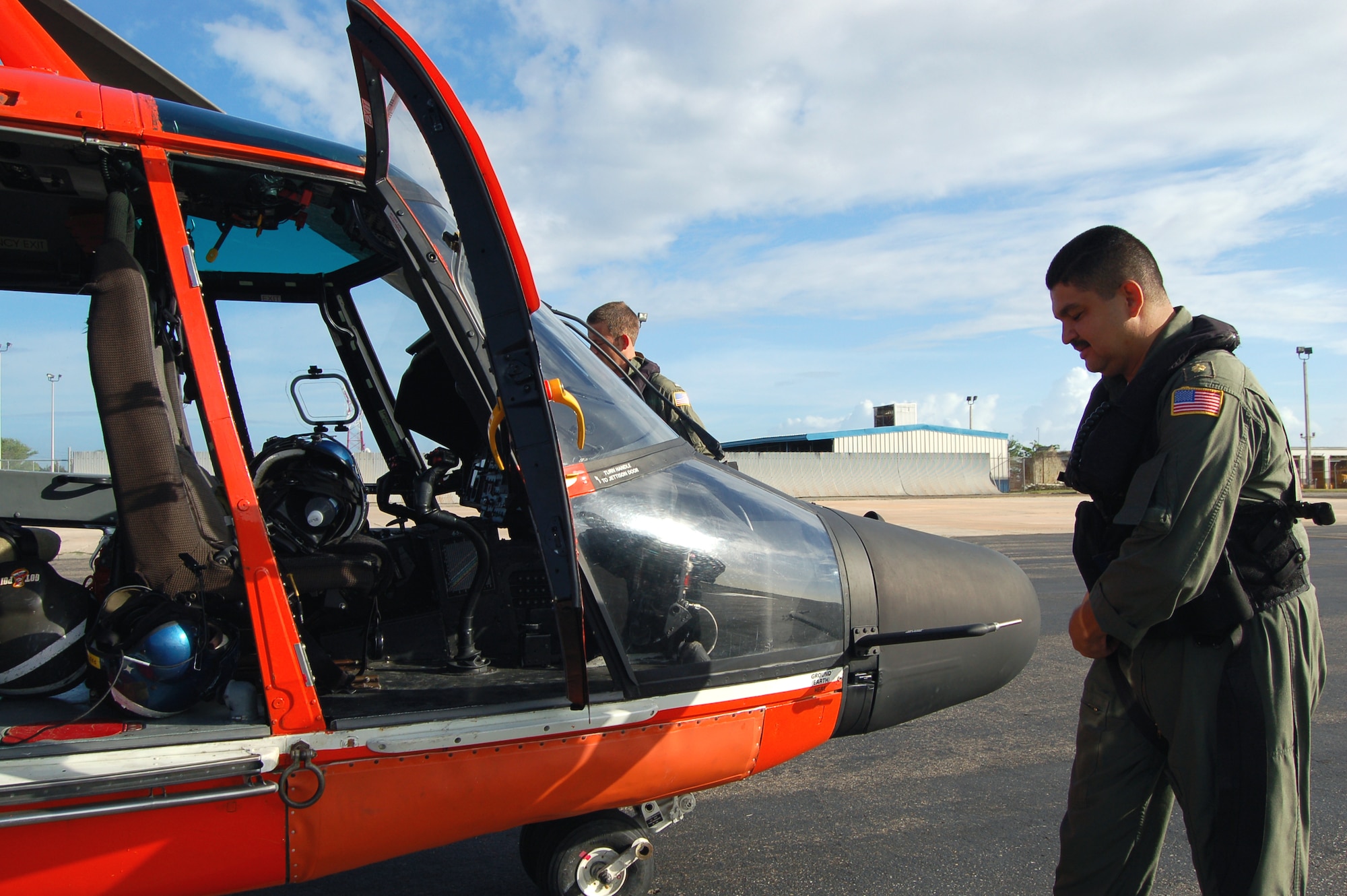 Coast Guard Lt. Cmdr. Juan Lopez does a preflight inspection on an HH-65C Dolphin prior to taking off on a training mission March 21 at Coast Guard Air Station Borinquen, Puerto Rico. The Coast Guard works with the Puerto Rican Police Department and helps them train on how to dive out from a helicopter to rescue people at sea. A former Senior Airman, Commander Lopez is an aircraft commander and the assistant operations officer at the air station. The Coast Guard provides a search and rescue capability for 1.2 million square miles around the Caribbean. (U.S. Air Force photo/Tech. Sgt. Ben Gonzales)