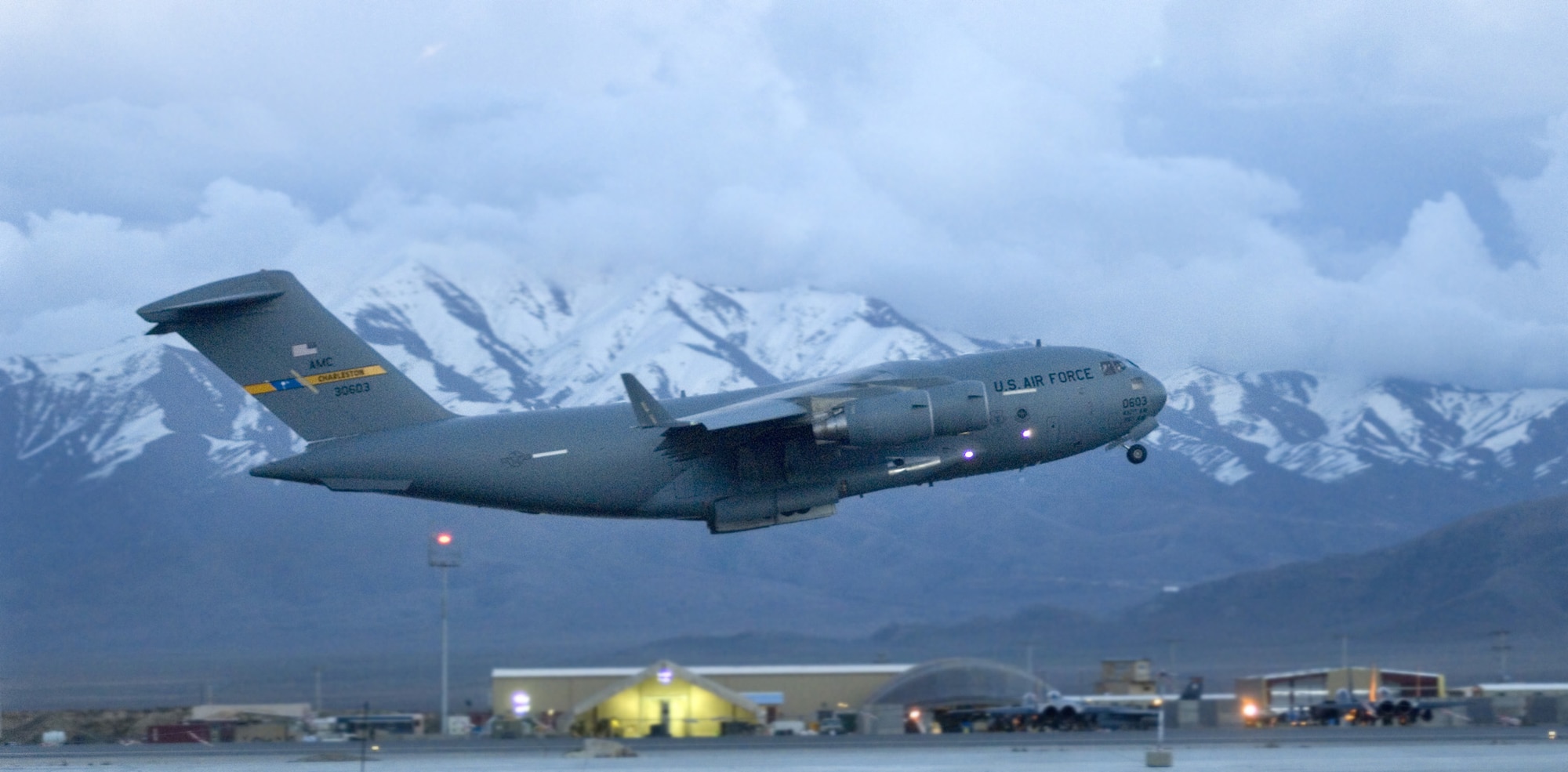A C-17 Globemaster III transport takes off at Bagram Airfield flightline, Afghanistan March 22 in support of Operation Enduring Freedom. C-130 Hercules and C-17s provide intratheater heavy airlift support, helping sustain operations throughout Afghanistan, Iraq and the Horn of Africa. (U.S. Air Force photo/Tech. Sgt. Cecilio M. Ricardo Jr.)