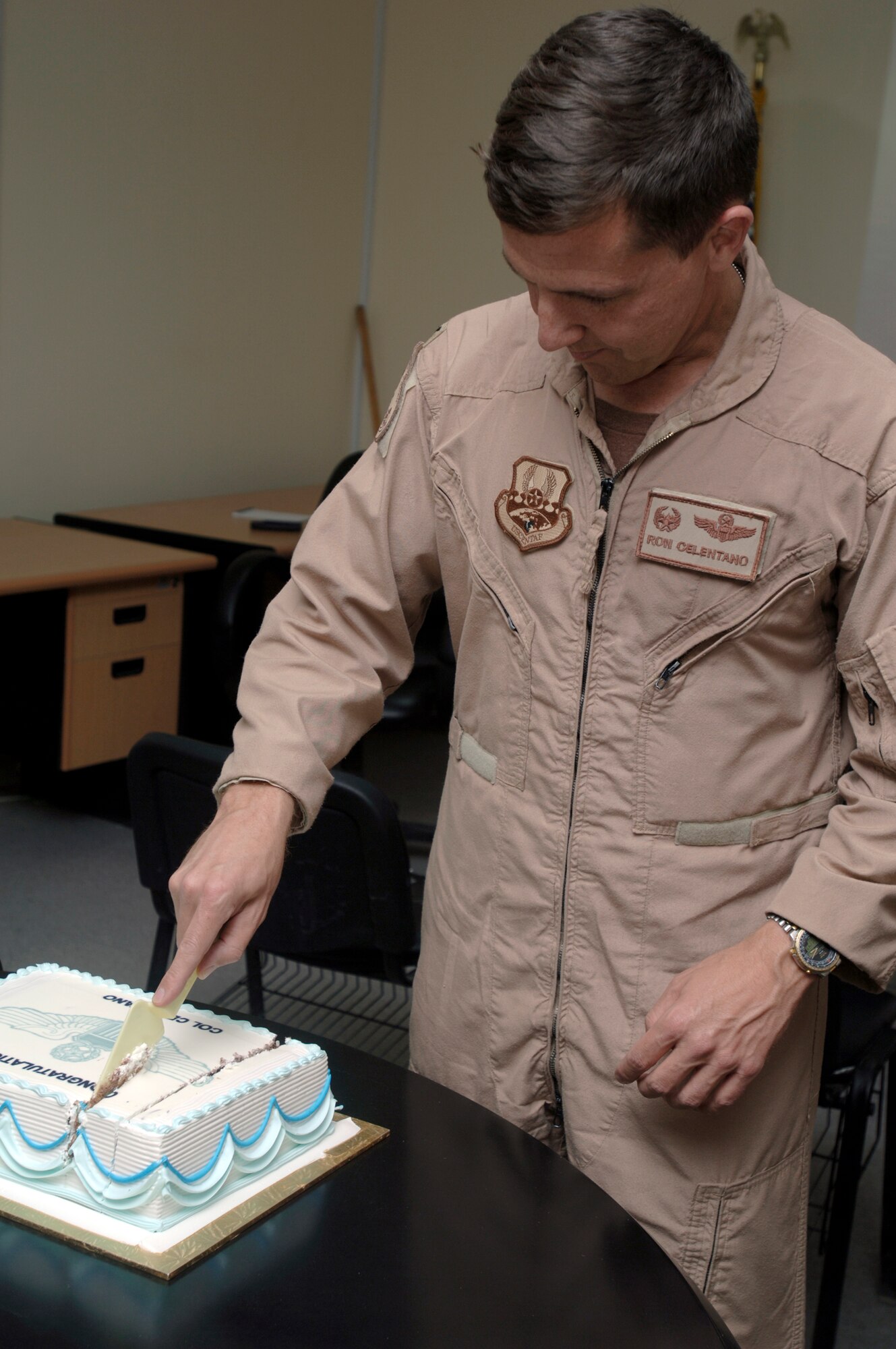 SOUTHWEST ASIA -- Newly awarded command pilot Col Ronald J. Celentano cuts his cake celebrating his achievement.  Col Celentano surpassed the 3000 flying hour milestone on Friday, 23 Mar 07 to earn his command pilot wings. (U.S. Air Force photo by Tech. Sgt. Edward D. Holzapfel) (Released)