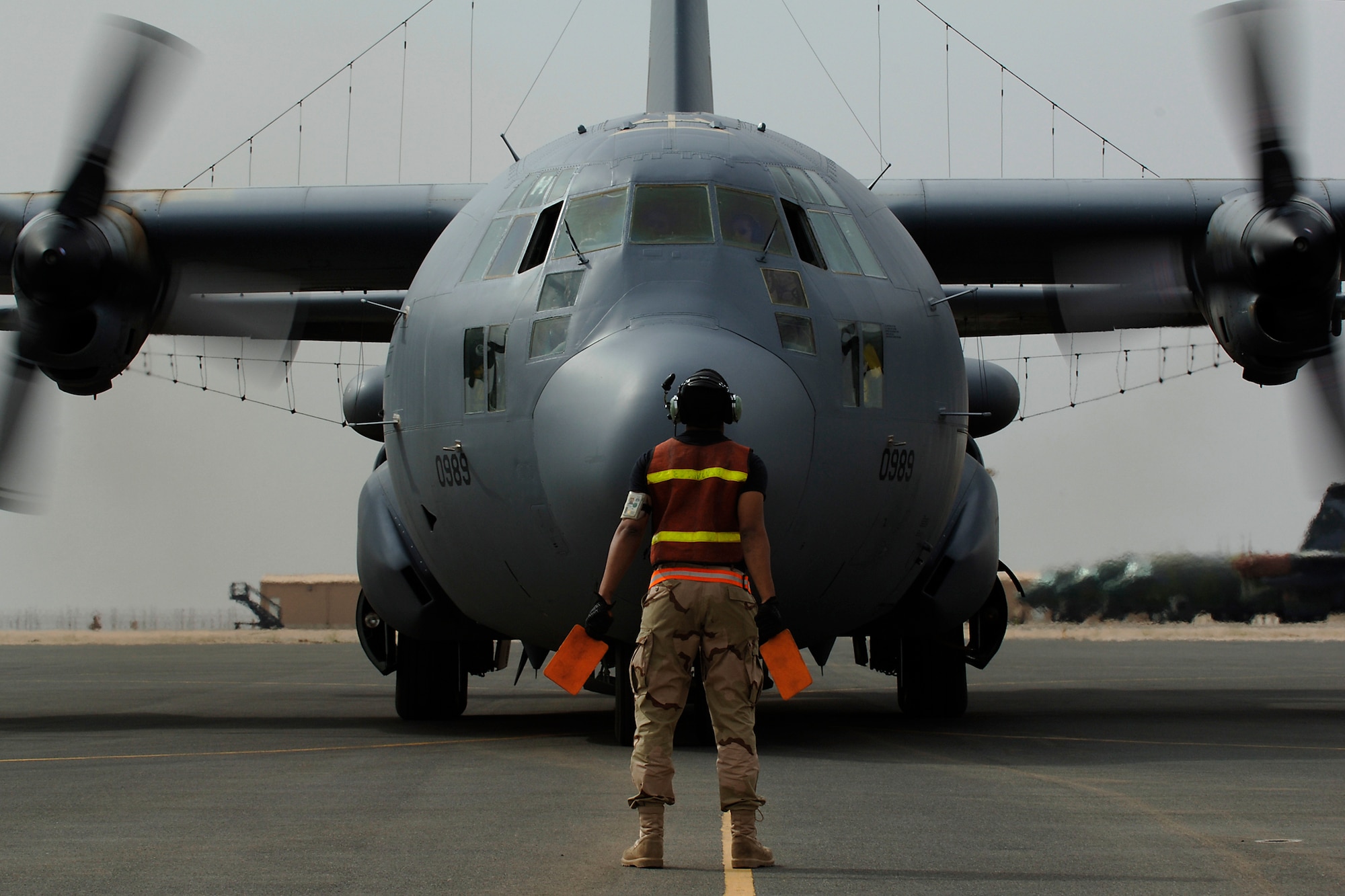 SOUTHWEST ASIA -- A1C Lance Griffin Sr. from the 43d Red Aircraft Maintenance Unit, directs newly awarded command pilot Col Ronald J. Celentano onto the aircraft parking ramp at an undisclosed location in southwest Asia on Friday, 23 Mar 07.  Col Celentano surpassed the 3000 flying hour milestone on Friday, 23 Mar 07 to earn his command pilot wings. (U.S. Air Force photo by Tech. Sgt. Edward D. Holzapfel) (Released)