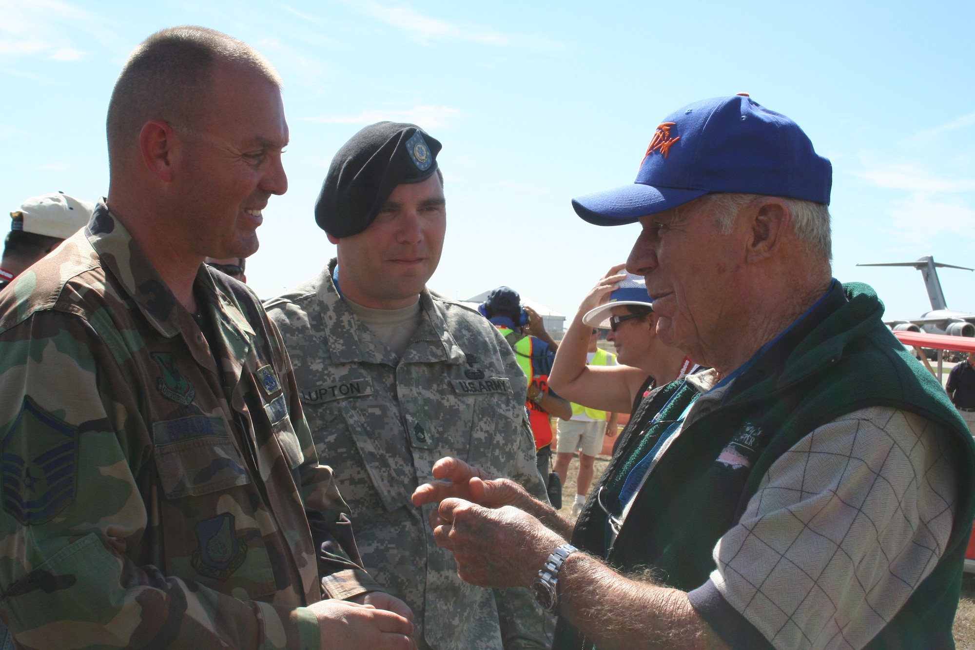 Master Sgt. J.J. Sprague, 18th Wing, Kadena Air Base, Japan, and Sergeant First Class Paul Lupton, U.S. Defense Attache Office Canberra, talk to retired General Chuck Yeager Friday at Australian International Airshow 07. The general was attending in honor of the 60th anniversary of breaking the sound barrier. (U.S. Air Force photo by Capt. Yvonne Levardi)