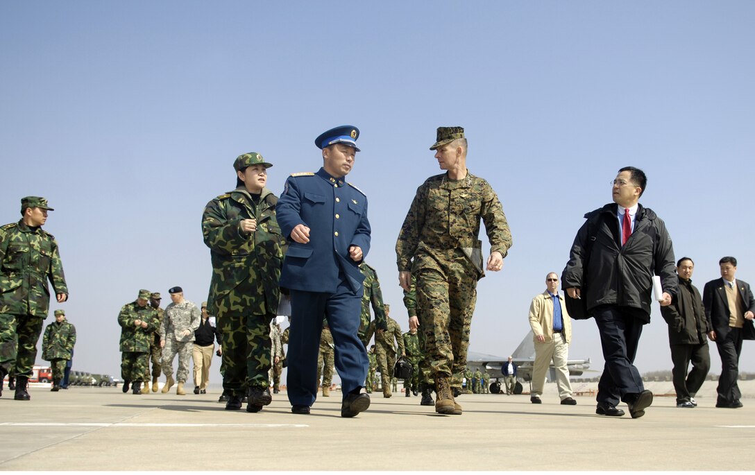 Chairman of the Joint Chiefs of Staff, Marine Gen. Peter Pace and Chinese Air Force Senior Col. Wang Wei walk the flight line at Anshan Airfield, China, March 24, 2007. 