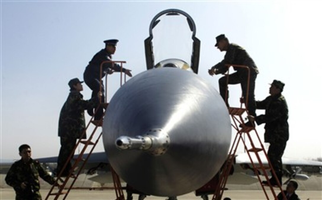 Chairman of the Joint Chiefs of Staff, Marine Gen. Peter Pace is offered to sit in the cockpit of the Chinese Su-27 Flanker fighter while he visits Anshan Airfield, China, March 24, 2007. 