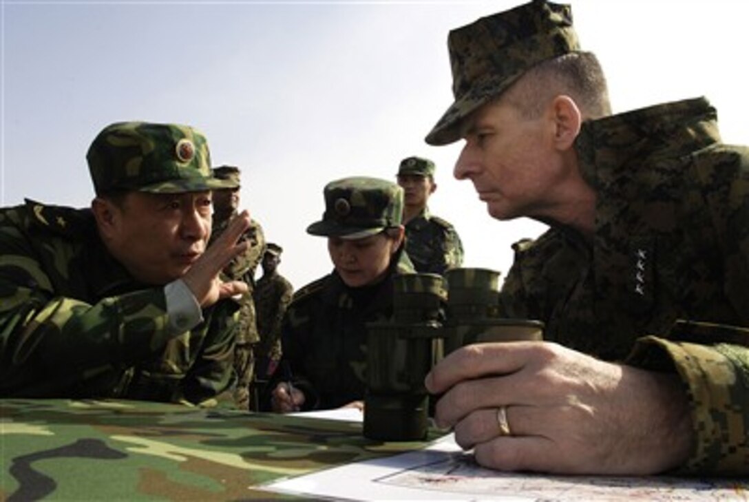 Chairman of the Joint Chiefs of Staff, Marine Gen. Peter Pace  is briefed by People's Liberation Army Gen. Ai Husheng while observing a reinforced armor company team conduct deliberate attack training exercise at Shenyang training base, China, March 24, 2007.