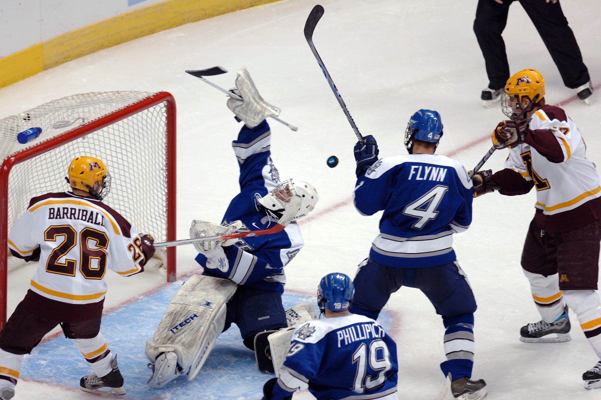 Falcon goaltender Andrew Volkening makes a blocker pad save in heavy traffic during the NCAA West Regional March 24 at the Pepsi Center in Denver. The freshman net minder made 33 saves in Air Force's 4-3 season-ending loss to the Minnesota Golden Gophers. (U.S. Air Force photo/Dave Armer)