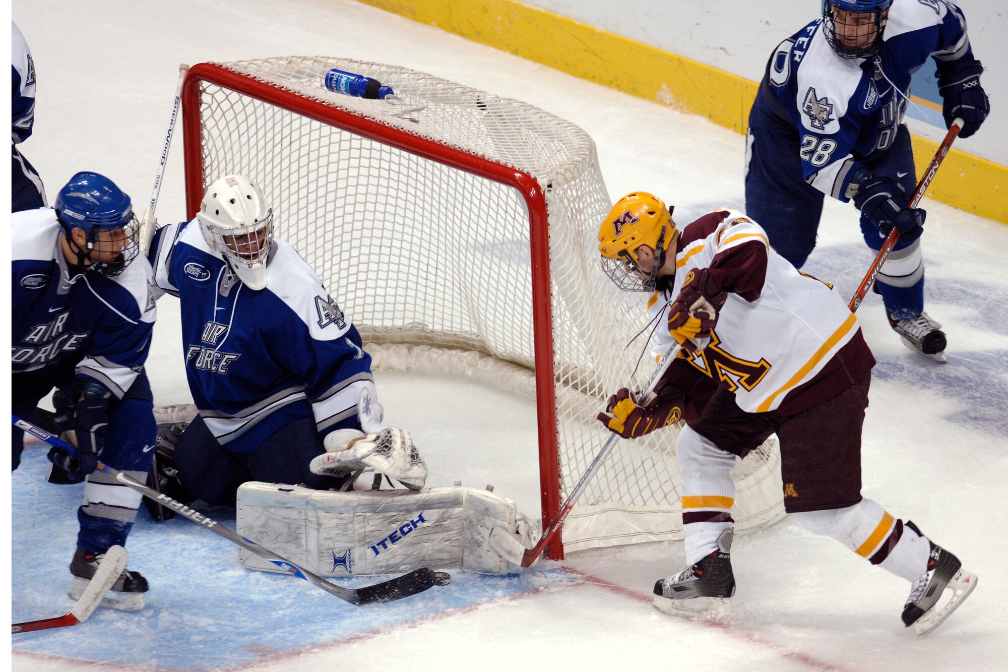 Falcon goalie Andrew Volkening makes a left pad save on a Minnesota forward during the NCAA West Regional March 24 at the Pepsj Center in Denver. The freshman net minder made 33 saves in his tournament debut. (U.S. Air Force photo/Dave Armer)