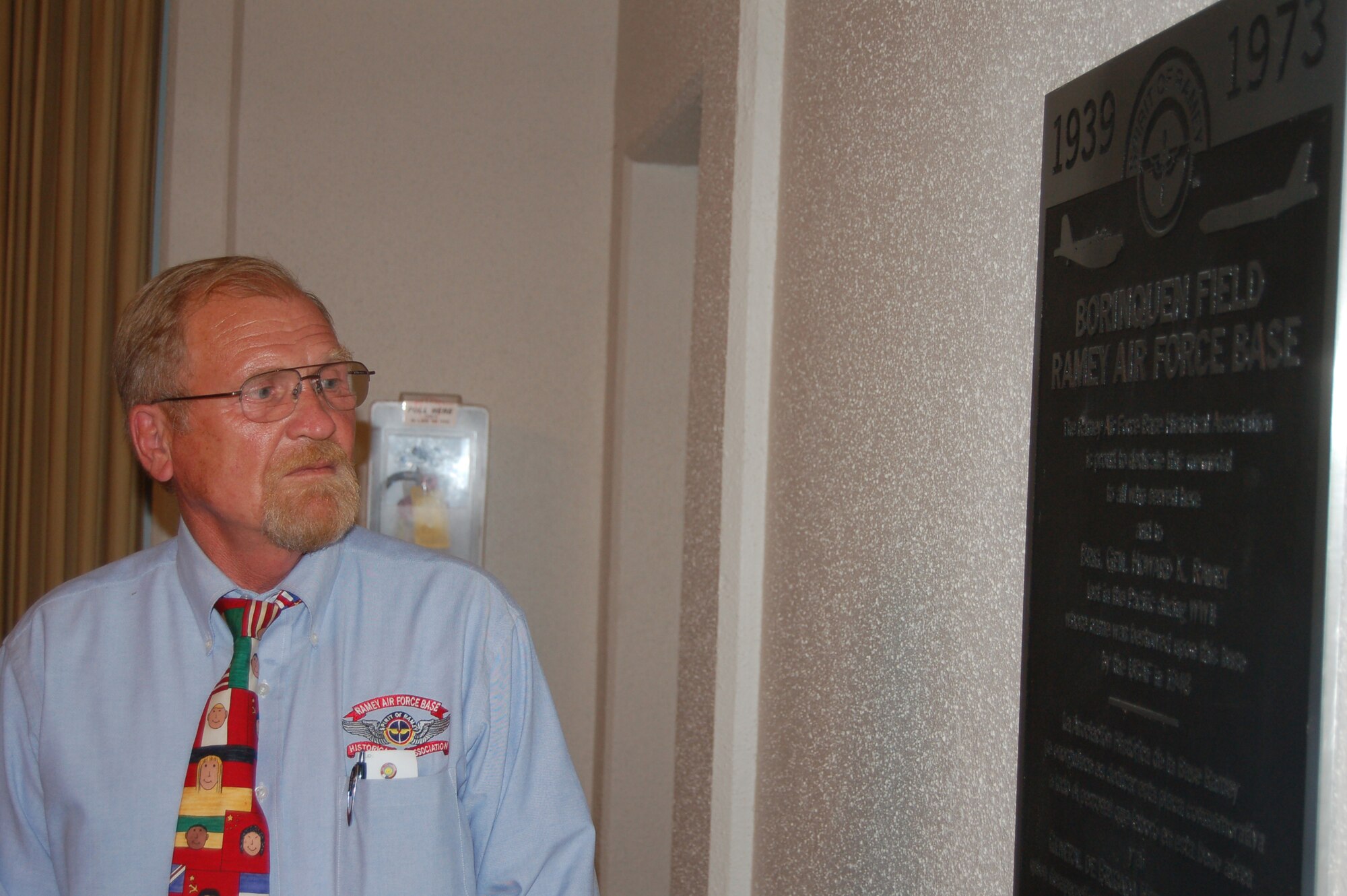 Michael Kud-Kudijaroff looks over a plaque dedicated by the Ramey Air Force Base Historical Association to the former Ramey Officers' Club at Coast Guard Air Station Borinquen, Puerto Rico. Mr. Kud-Kudijaroff grew up in Berlin and received a chocolate bar dropped by retired Col. Gail Halvorsen from a C-54 Skymaster during the Berlin Airlift in 1948. Mr. Kud-Kudijaroff met Colonel Halverson for the first time during the Ramey AFB Historical Association Reunion held here at the former Air Force base, which closed in 1973. (U.S. Air Force photo/Tech. Sgt. Ben Gonzales)