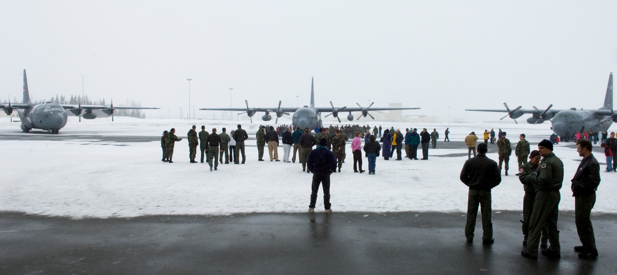 ELMENDORF AIR FORCE BASE, Alaska - People crowd around the final 517th Airlift Squadron C-130s welcoming home its passengers and saying goodbye to the past. After 43 years of continuous service in Alaska, the C-130 is leaving to fulfill a reorganization of aircraft basing to make its mission more efficient. C-17s are replacing the C-130s and will start supporting the 517th Airlift Squadron in June. (U.S. Air Force photo by Senior Airman Garrett Hothan)