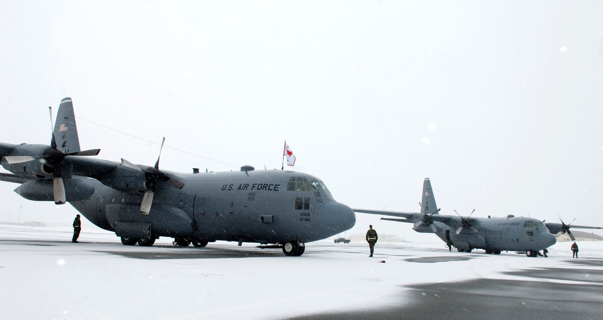 ELMENDORF AIR FORCE BASE, Alaska - Maintainers from the 703rd Aircraft Maintenance Squadron ready two 517th Airlift Squadron C-130s for the disembarkment of its last passengers here. After 43 years of continuous service in Alaska, the ceremonial shut down of two of the three remaining C-130 stationed here marked the end of the C-130 era with the 517th AS. (U.S. Air Force photo by Senior Airman Garrett Hothan)