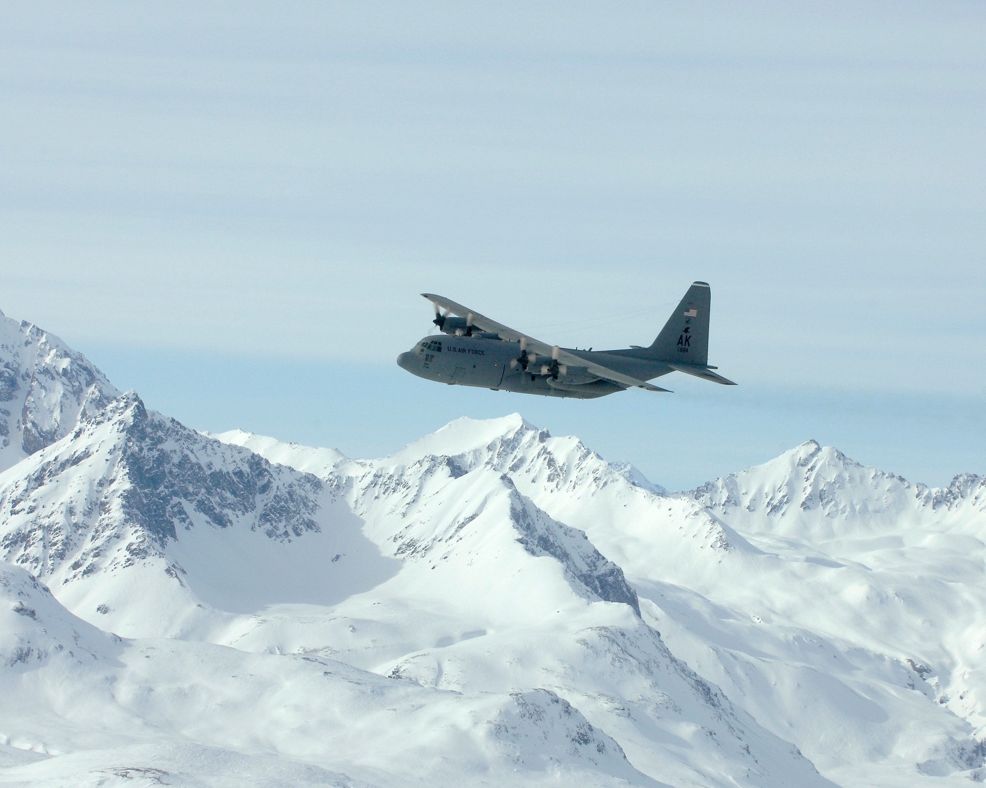 OVER ALASKA -- A C-130 flys over the Alaska Range during its final flight for the 517th Airlift Squadron March 23. After 43 years of continuous service in Alaska, the flight marked the end of the C-130 era at the 517th AS and will see the C-17 taking over the mission soon. (U.S. Air Force photo by Tech. Sgt. Keith Brown)