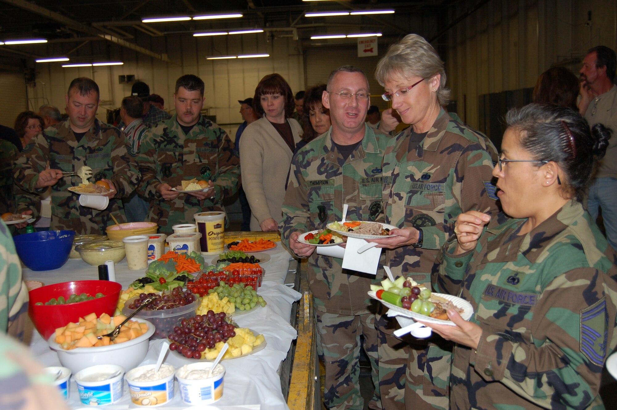Senior Master Sgt. Deborah Francavilla, Tech. Sgts. Lynn Fyanes, and Andrew Thompson, from the 75th Logistics Readiness Squadron at Hill AFB, UT., were among the first in line to grab a bite to eat from the food spread that was laid in honor of Airmen who recently returned home. Sergeant Francavilla and Thompson were deployed to Qatar and Sergeant Fyanes deployed to Kuwait.
