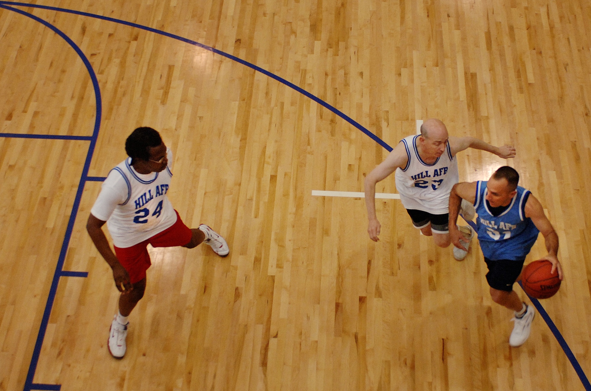 Senior Master Sgt. John Barnhouse, 729th Air Control Squadron, drives to the goal during the commanders vs. chiefs basketball game commemorating the start of this year's Air Force Assistance Fund campaign at Hill Air Force Base, Utah.  The chiefs fell behind early but managed to rally a late game come-back but fell short ultimately losing the game. Team Hill members in attendance were also treated to a half-time dance show put on by the ladies of the NBA's Utah Jazz dance team. Members in attendance also received door prizes presented by Kelsey Brigel, Miss Teen Utah as part of the event's festivities.  