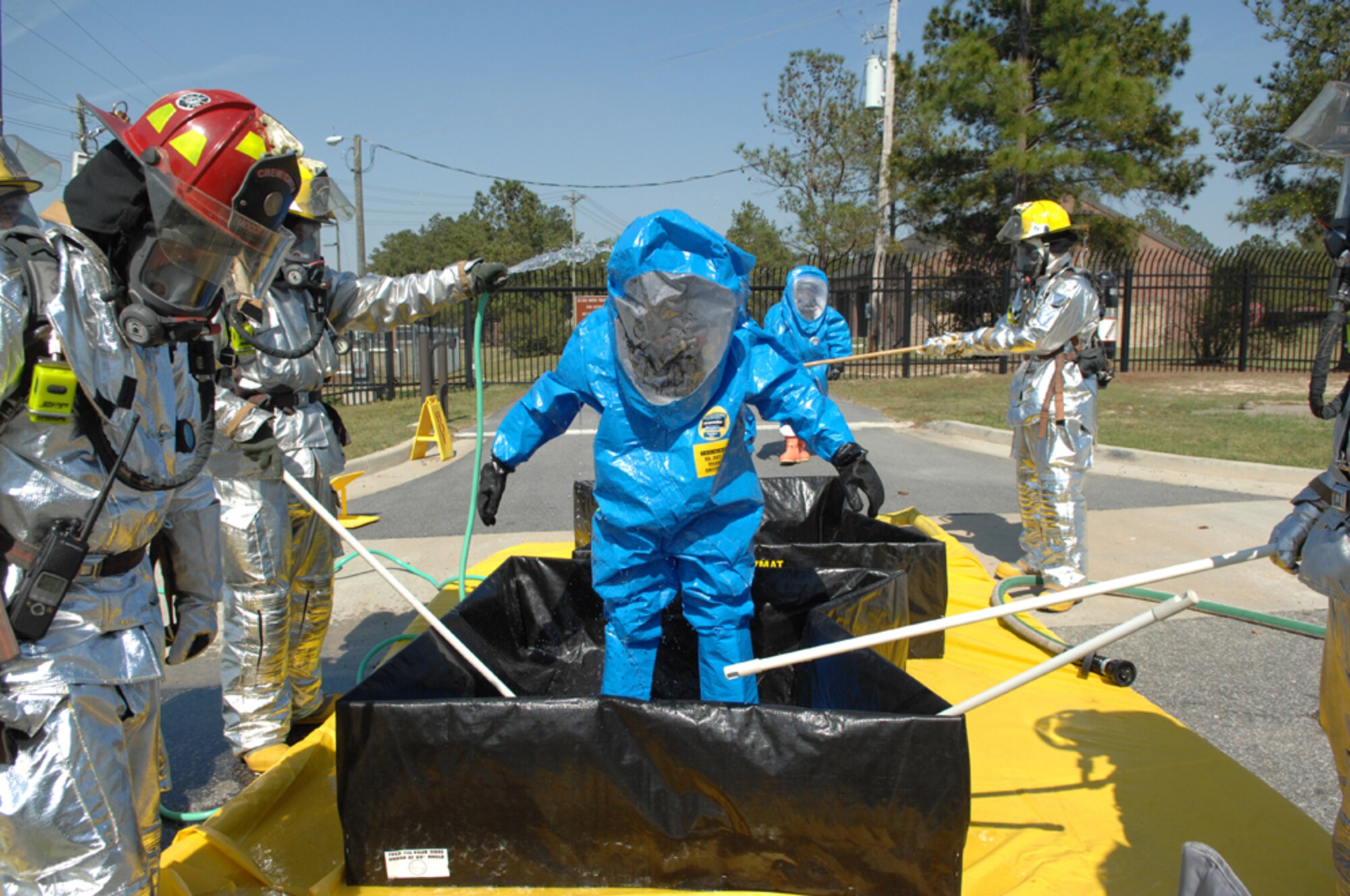 MOODY AIR FORCE BASE, Ga. -- Members of the 23rd Civil Engineer Squadron, Moody Air Force Base, Ga., wear level A chemical suits as they decontaminate another Team Moody member after fixing a chlorine gas cylinder leak during the Operational Readiness Exercise "Commando Angel" March 19. The exercise, held March 19-23, tests the base's ability to rapidly deploy and operate in a simulated forward operating location.(U.S. Air Force photo by Airman 1st Class Gina Chiaverotti)