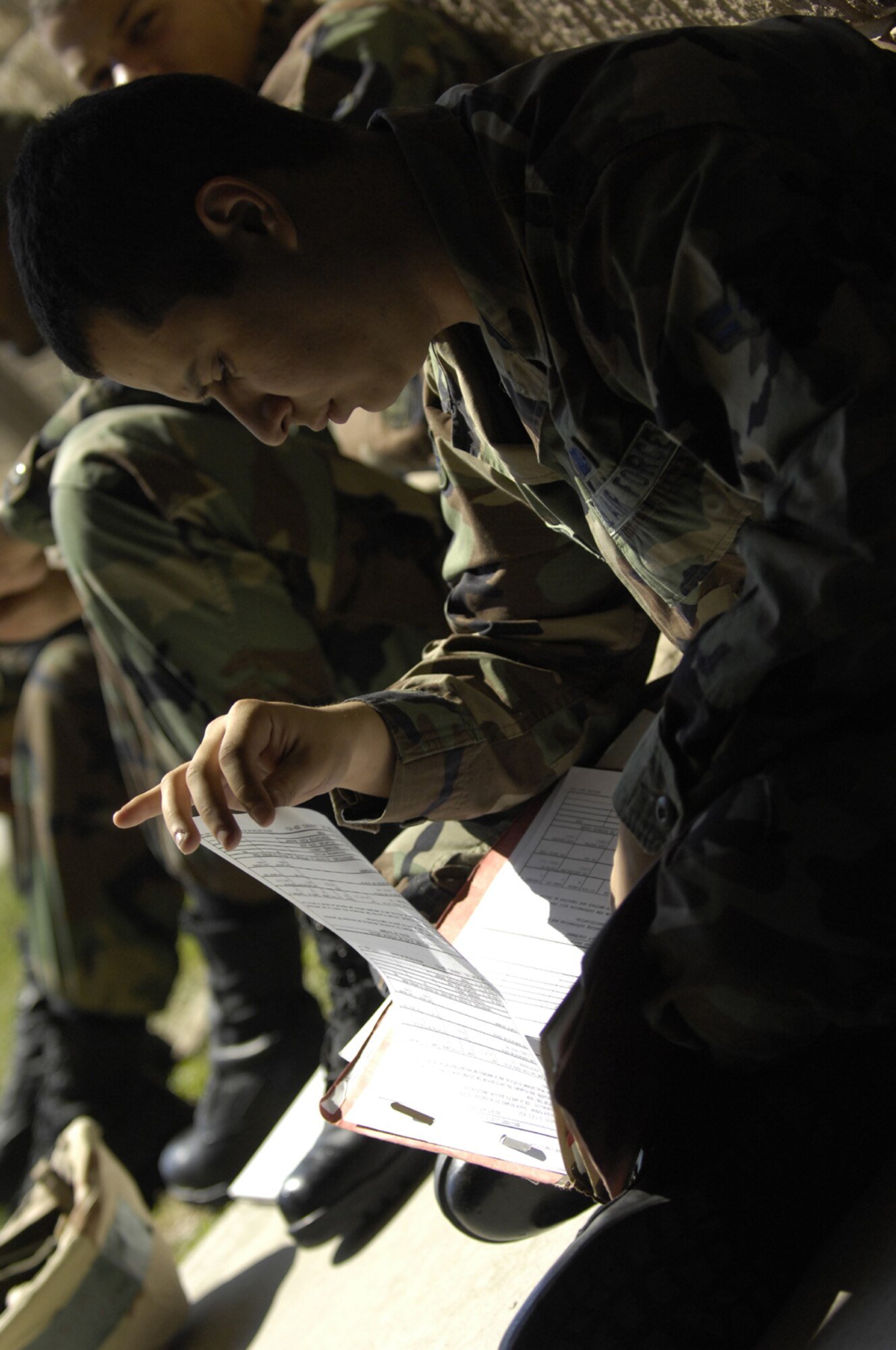 MOODY AIR FORCE BASE, Ga. -- Airman 1st Class Luis Moncayo, 23rd Logistics Readiiness Squadron, looks through his mobilty folder while waiting for the deployment line at Moody Air Force Base, Ga. March 19. Processing through the deployment line was conducted as part of the base Operatonal Readiness Exercise ''Commando Angel" held March 19-23 to test the base's ability to rapidly deploy and operate in a simulated forward operating location. (U.S. Air Force photo by Staff Sgt. Manuel J. Martinez) 