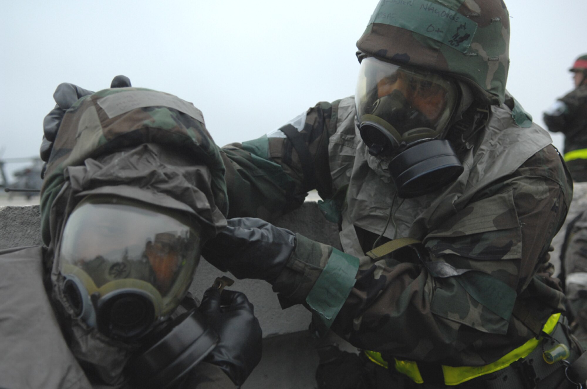 MOODY AIR FORCE BASE, Ga. -- Two Team Moody members use the "buddy system" to ensure their chemical masks are properly donned during the base's Operational Readiness Exercise held March 19-23. The exercise test the base's ability to rapidly deploy and operate in a simulated forward operating location. (U.S. Air Force photo by Airman1st Class Gina Chiaverotti)