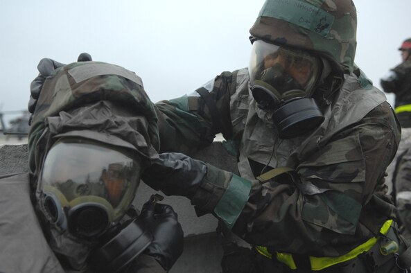 MOODY AIR FORCE BASE, Ga. -- Two Team Moody members use the "buddy system" to ensure their chemical masks are properly donned during the base's Operational Readiness Exercise held March 19-23. The exercise tested the base's ability to rapidly deploy and operate in a simulated forward operating location. (U.S. Air Force photo by Airman1st Class Gina Chiaverotti) 
