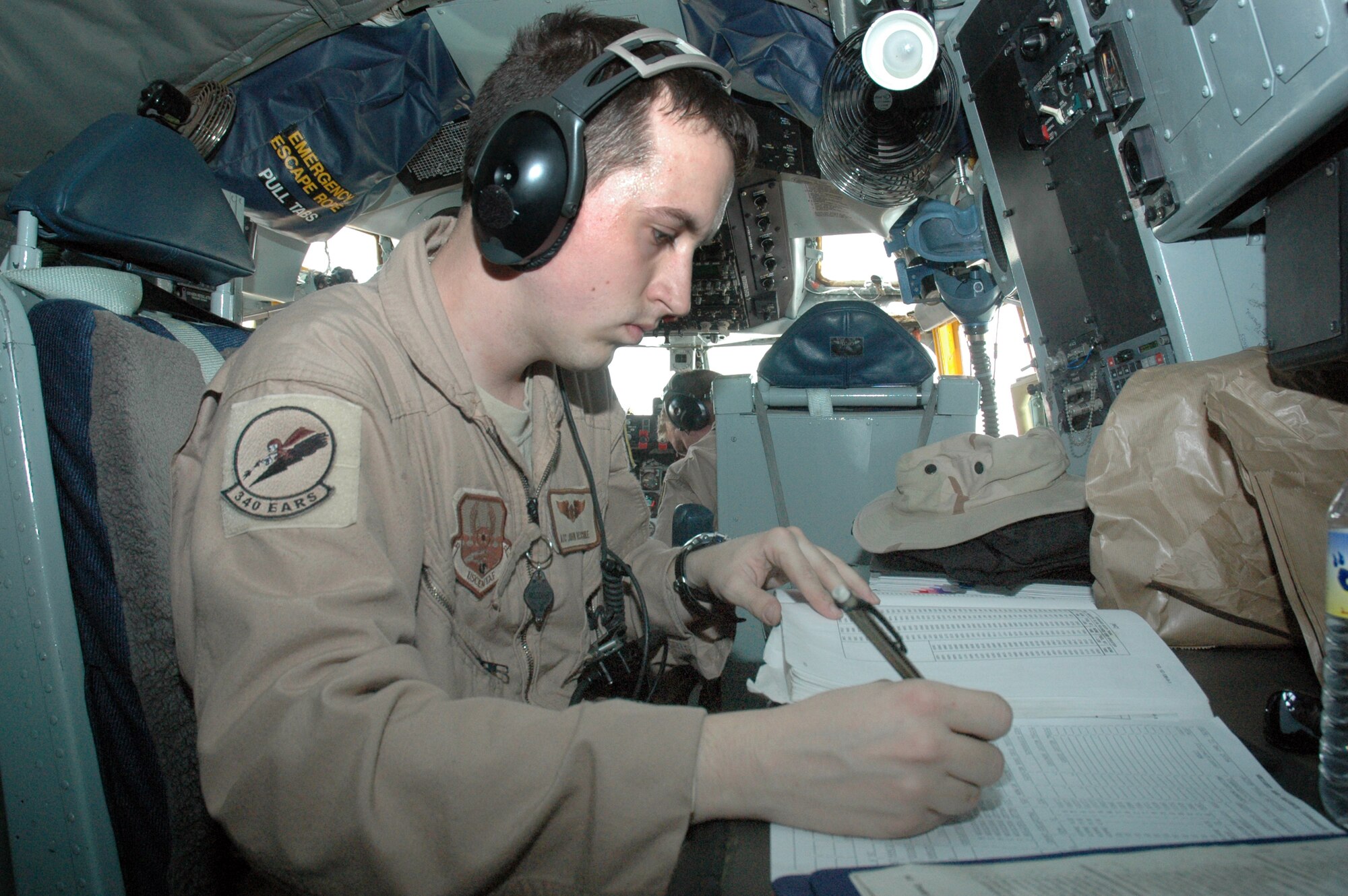 Airman 1st Class John Reschke calculates the weight and balance of a KC-135 Stratotanker March 22 before takeoff from a forward deployed location for a refueling mission.   Airman Reschke is a tanker boom operator for the 340th Air Refueling Squadron.  The aircrews refuel a variety of coalition aircraft throughout the region with aircraft that are oftentimes twice the age of the Airmen who fly and maintain them. . (U.S. Air Force photo/Senior Airman Erik Hofmeyer)