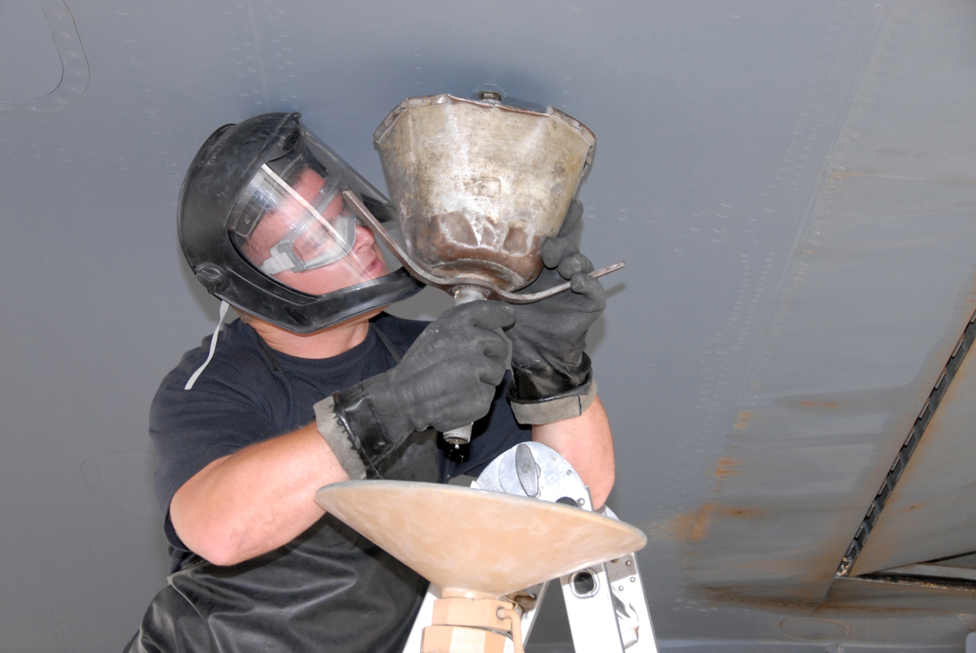 Senior Airman Neal Sicard prepares a KC-135 Stratotanker for maintenance work on its fuel cell March 21 by draining the main fuel tank sumps.  Airman Sicard is a crew chief assigned to the 340th Aircraft Maintenance Unit at a forward deployed location.  The 340th AMU maintainers ensure tankers are fully mission ready to provide fuel to a variety of coalition aircraft throughout the region. (U.S. Air Force photo/Airman 1st Class Gustavo Gonzalez)