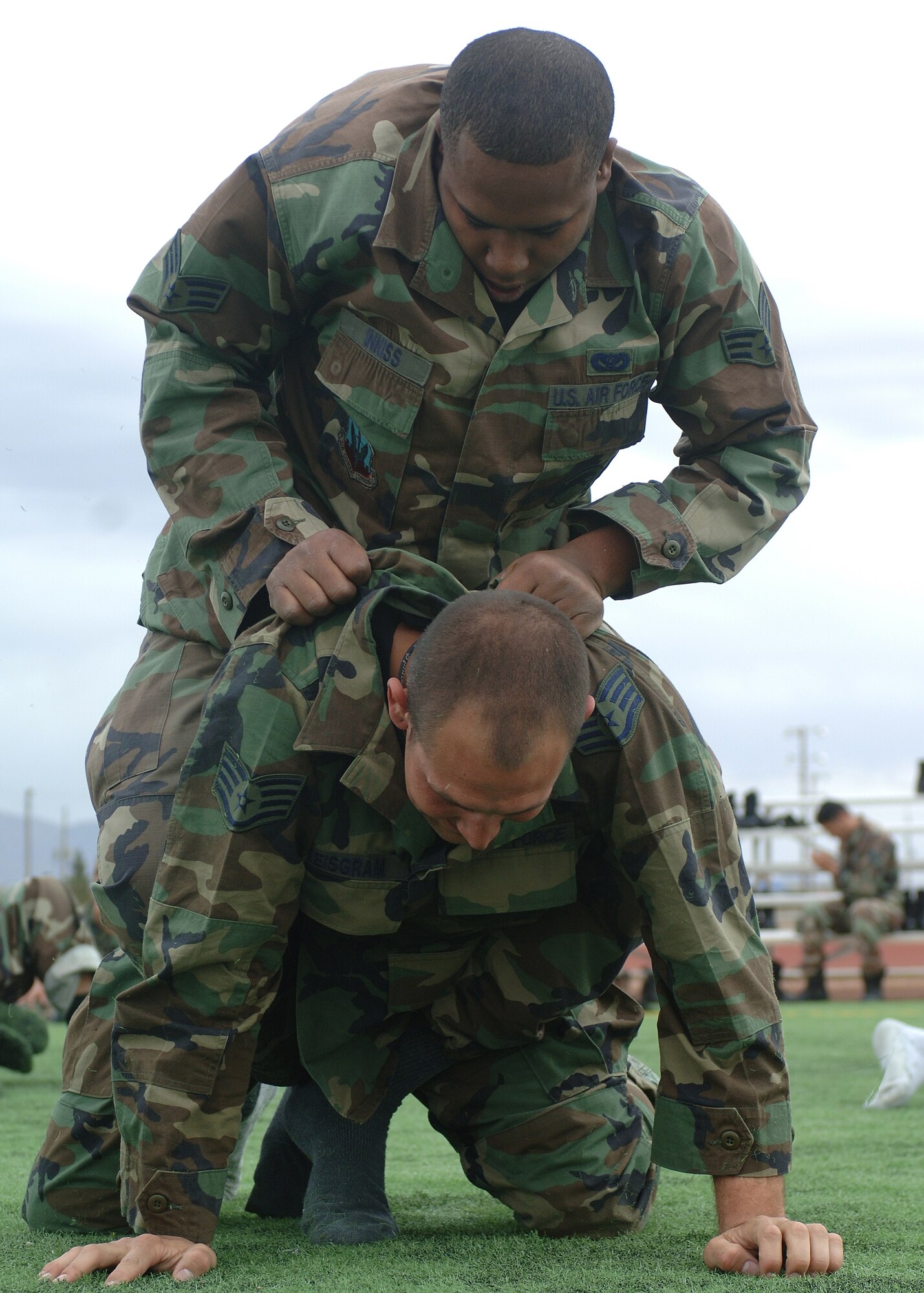 Senior Airman Frank Inniss and Staff Sgt. Tyler Weisgram, both of the 49th Civil Engineer Squadron, practice the hand-to-hand combat techniques learned from Army Soldiers who traveled to Holloman March 21. (U.S. Air Force photo by Airman 1st Class John Strong)