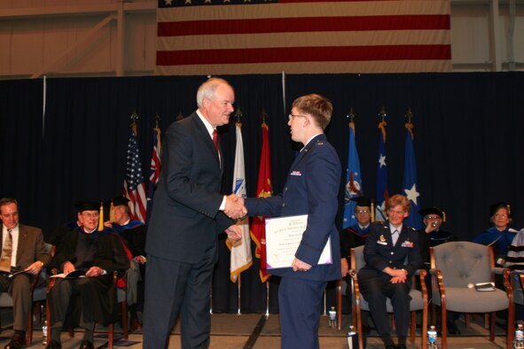 WRIGHT-PATTERSON AIR FORCE BASE, OHIO -- Secretary Wynne congratulates 2nd Lt. Bobby Birrer on his graduation from the Air Force Institute of Technology during commencement ceremonies March 22 at the National Museum of the U.S. Air Force.  Lt. Birrer earned a master of science degree in computer engineering. Wynne is a 1970 graduate of AFIT.  Air Force photo by Bill Hancock.