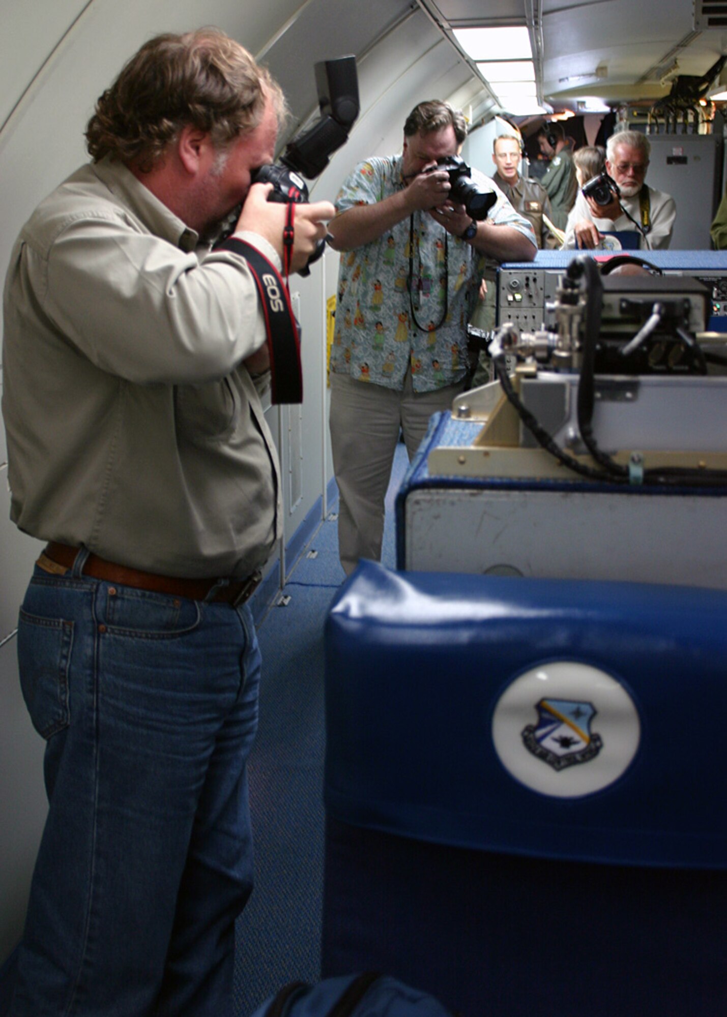 (TINKER AIR FORCE BASE, OKLA) Photographers from the local media get pictures of 552nd Air Control Wing Airmen conducting aerial surveillance during the E-3 Sentry's 30th anniversary flight on Mar. 23.  The E-3 first arrived at here on Mar. 23, 1977, and Airmen here have conducted the same mission for 30 years. (Air Force photo by Staff Sgt. Stacy Fowler)