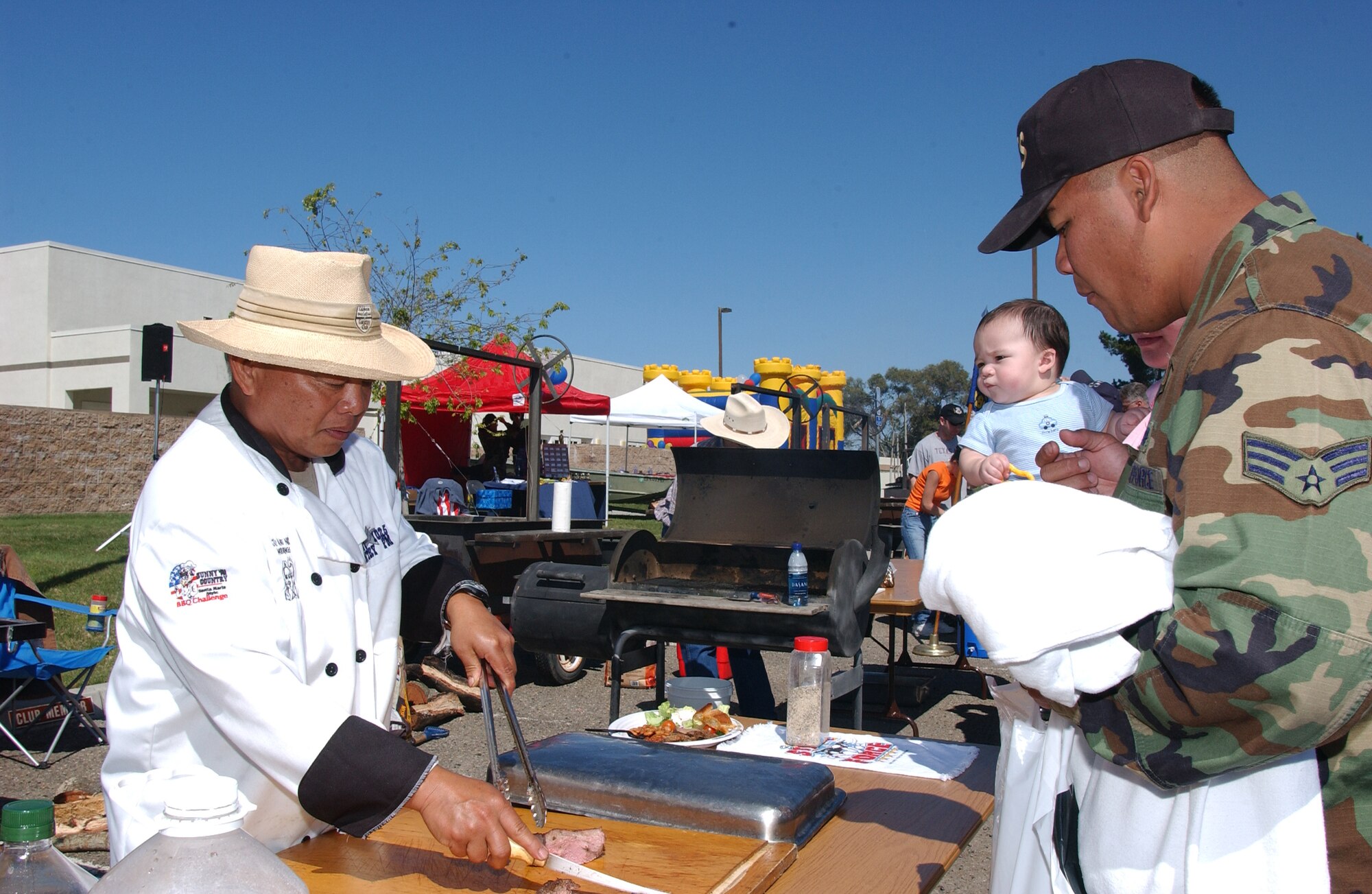 During 30th Services Focus Day, Airmen, their families and civilians sample Santa Maria-style barbecue tri-tip before the judges' taste test for the Vandenberg Ultimate Tri-tip Challenge March 15. Ten teams distributed samples to a crowd of hundreds during the event held to attract and inform the Vandenberg community to the many events offered on base. (U.S. Air Force photo by Airman 1st Class Adam Guy)