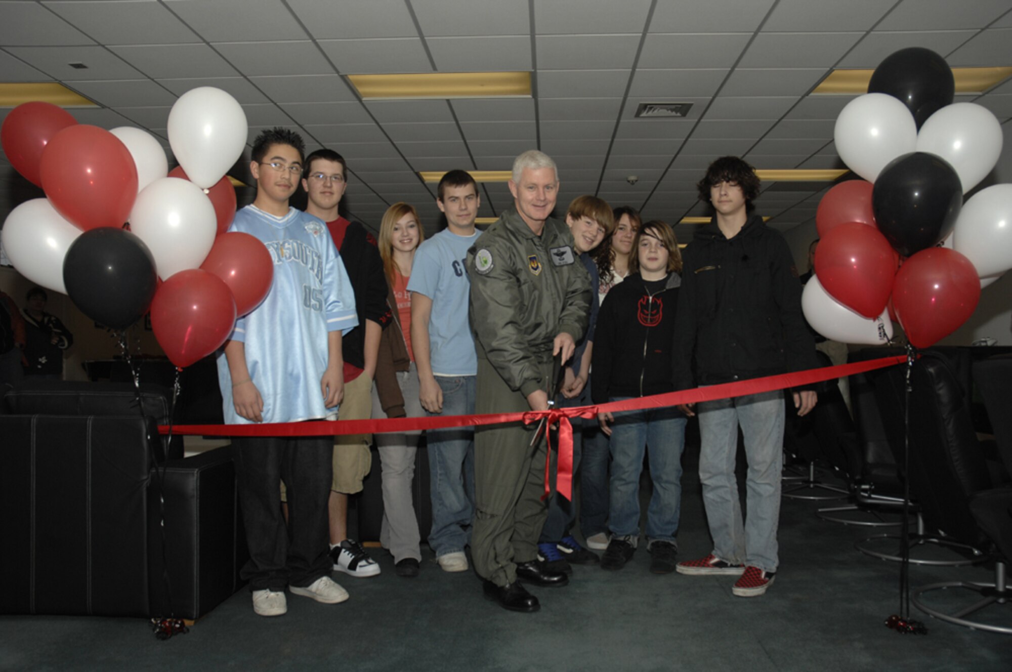 Brig. Gen. Robert Steel, 48th Fighter Wing commander and Liberty teens cut the grand opening ribbon at the newly renovated Teen Center. The newly painted facility houses new pool and ping pong tables, sofas, air hokey, flat screen televisions and exercise equipment. The teen center is open Wednesdays and Thursdays 3 to 8 p.m. and Fridays and Saturdays 3 to 11 p.m.