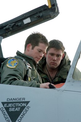 Capt. David Kirkendall, left, a pilot with the active-duty's 81st Fighter Squadron, inspects the maintenance forms for A-10, number 122, with 442nd Fighter Wing crew chief, Airman 1st Class Jeremy Cline February 11 on the Whiteman Air Force Base flight line. Pilots from Spangdahlem Air Base, Germany, are flying with the 442nd for three months, starting in February, to catch up on training flights. Airman Cline, an Air Force Reservist, is on 90-day orders to help support the additional training sorties from Whiteman AFB, Mo.  (U.S. Air Force photo/Maj. David Kurle) 