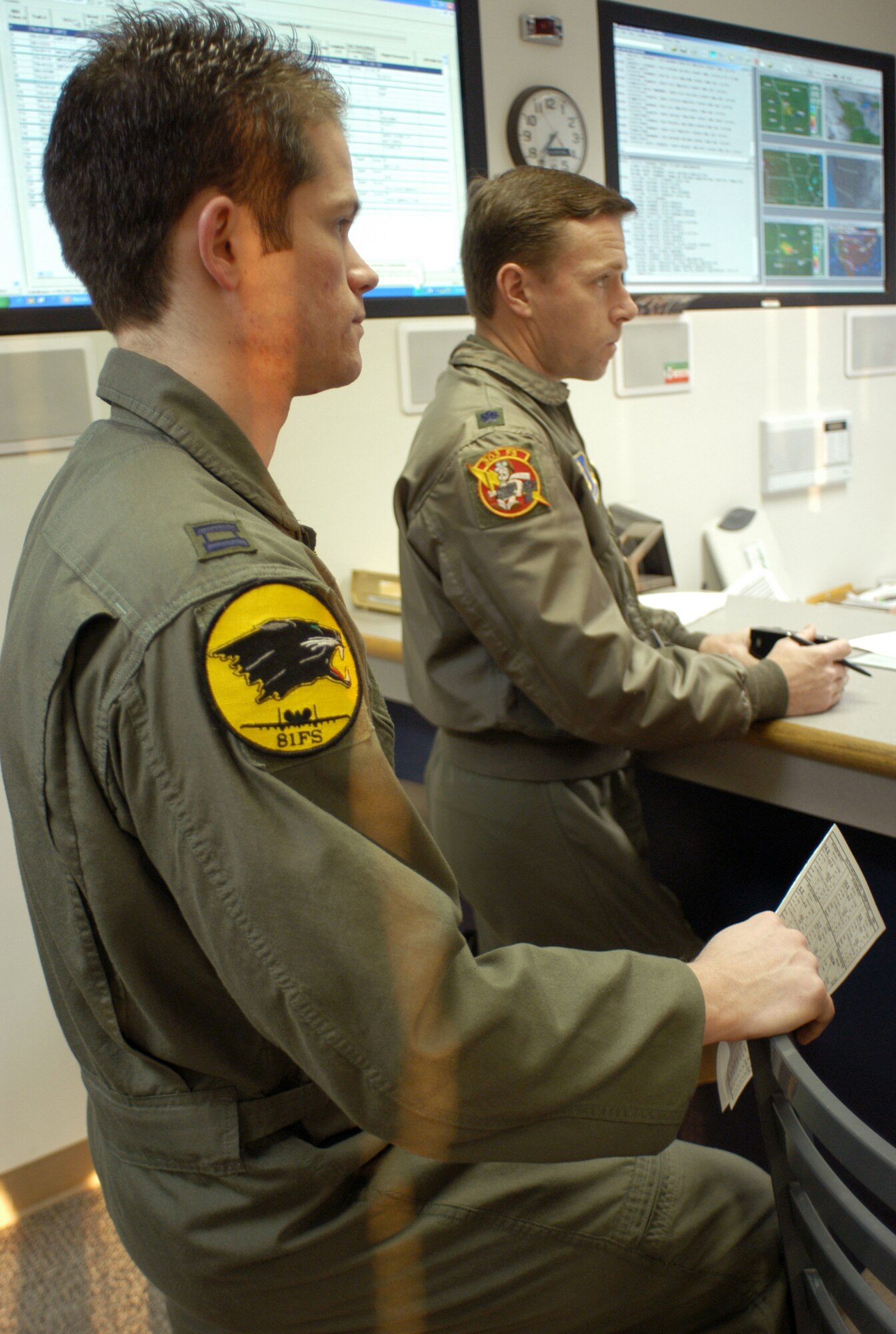 Capt. David Kirkendall, left, an active-duty A-10 pilot from the 81st Fighter Squadron, Spangdahlem Air Base, Germany, and Lt. Col. Stephen Chappel, director of operations in the Air Force Reserve's 303rd Fighter Squadron, receive a briefing from the 303rd FS supervisor of flying at Whiteman Air Force Base, Mo., Feb. 11.  Captain Kirkendall is one of 20, 81st FS pilots who will be flying with the Reserve's 442nd Fighter Wing to catch up on training sorties unavailable to them in Germany.  Captain Kirkendall is also receiving "lead upgrade" training while flying at Whiteman so he can lead A-10 formations when he goes back to his unit in Germany.  (U.S. Air Force photo/Maj. David Kurle)