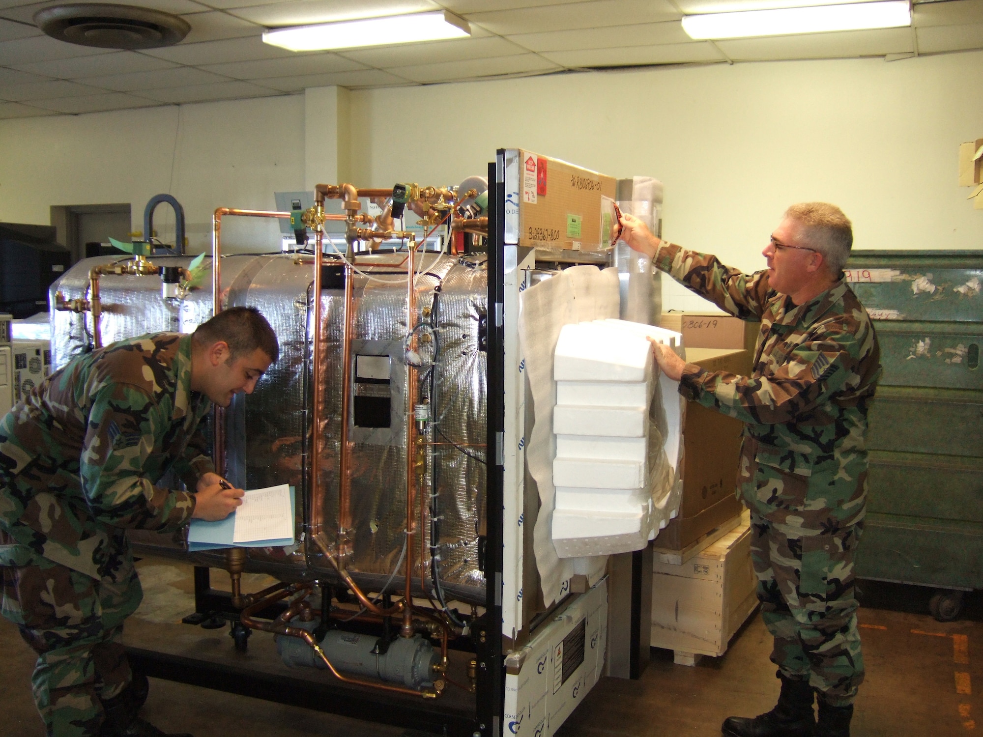 Staff Sgt. Joseph Ruisi and Tech. Sgt. Tony Belcher, members of the 882nd Training Support Squadron, unwrap and inspect a new sterilizer for a surgery course.  The 882nd TRSS recently won the AETC award for Technical Support Squadron of 2006. (U.S. Air Force photo/Courtesy of 882 TRSS)