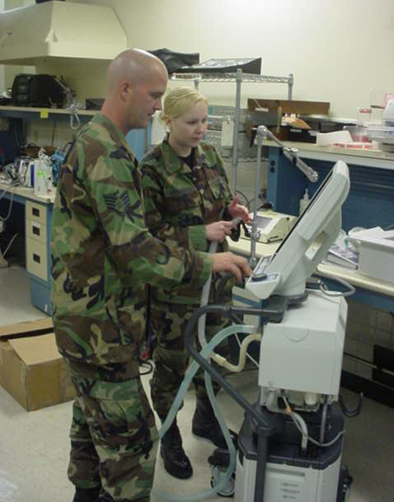 Tech. Sgt. Stephen Williams and Senior Airman Inna Hernandez, members of the 882nd Technical Training Squadron, test and repair a ventilator.  The 882nd TRSS recently won the AETC award for Technical Support Squadron of 2006.  (U.S. Air Force photo/Courtesy of 882 TRSS)