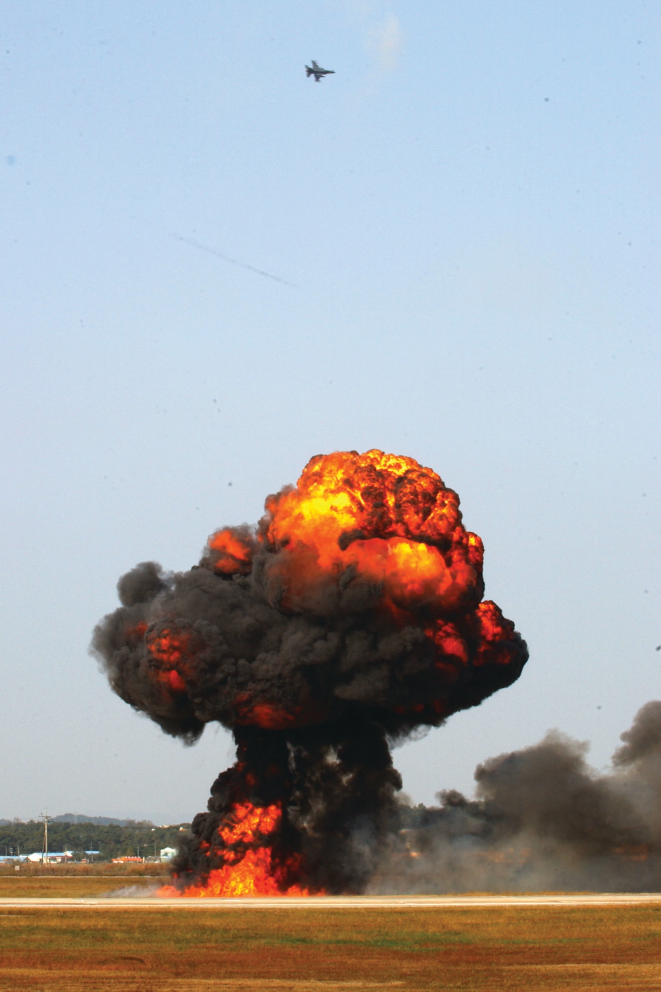 OSAN AIR BASE, Republic of Korea --  During the combat search and rescue demonstration at the 2006 Air Power Day, 51st Civil Engineer Squadron Explosive Ordnance Disposal personnel exploded ground pyrotechnics after an F-16 simulated dropping a bomb. (U.S. Air Force photo by Airman Jason Epley)