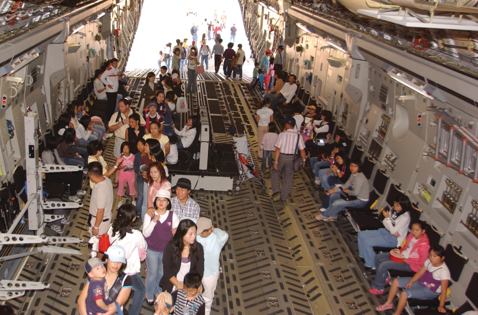 OSAN AIR BASE, Republic of Korea --  Visitors look at the cargo area of a C-17 during the 2006 Air Power Day air show here. Many of the larger planes and helicopters were opened for people to look and walk around inside. (U.S. Air Force photo by Airman Jason Epley)
