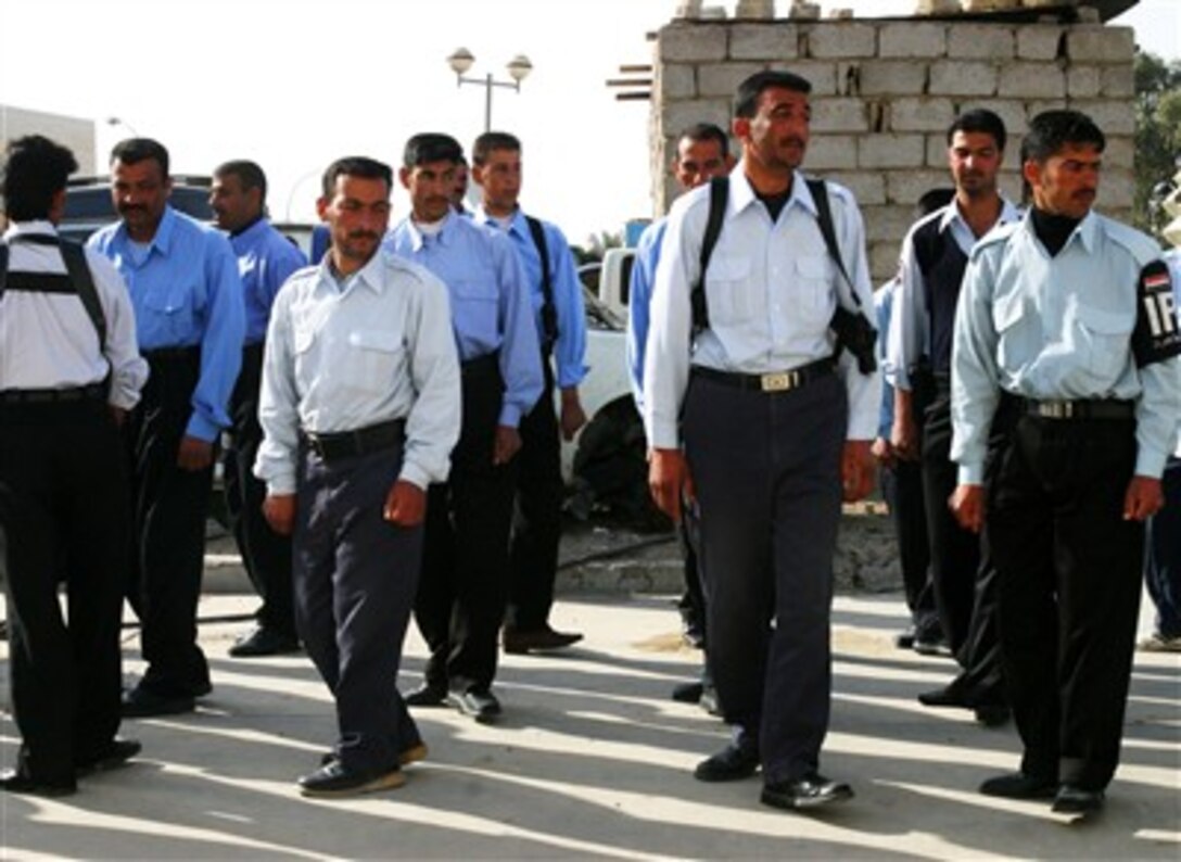 The chief of the Ferris police station puts his policemen in formation for their morning physical training in front of the station, March 15, 2007, in Ferris, Iraq. 