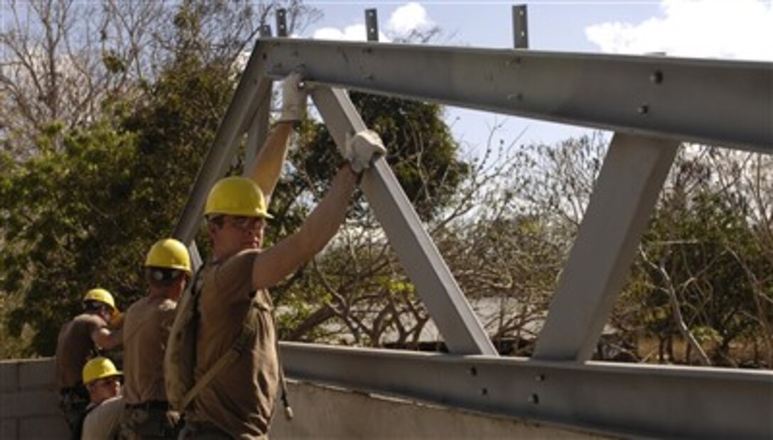 U.S. Army soldiers stabilize rafters during construction of a school in La Calera, Nicaragua, March 23, 2007. The soldiers, from the 153rd Engineer Battalion, South Dakota Army National Guard, and deployed with the U.S. Air Force's 820th Expeditionary Red Horse Squadron, are participating in New Horizons-Nicaragua 2007, a joint humanitarian and training exercise with the Nicaraguan military.