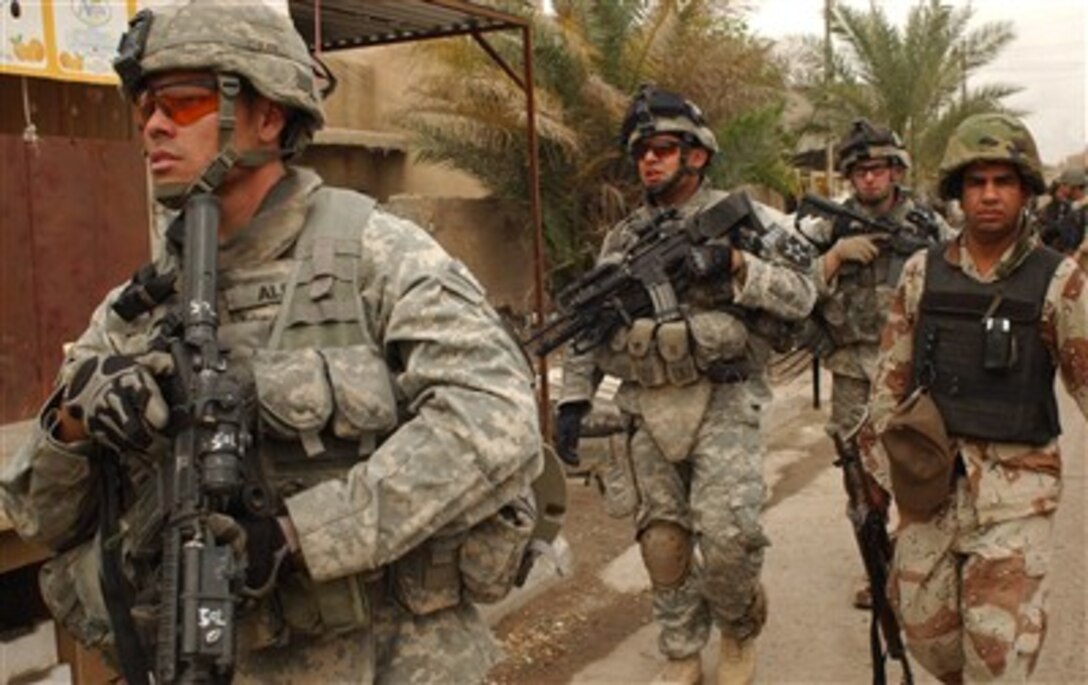 From left, U.S. Army Staff Sgt. Juan Alba, Cpl. Joseph Casiano, Spc. David Tunstall and an Iraqi National Police officer conduct a combined cordon and search foot patrol at a market in Ghazaliya, Iraq, March 23, 2007. The soldiers are from Black Hawk Company, 1st Battalion, 23rd Infantry Regiment, 3rd Brigade Combat Team, 2nd Infantry Division. 