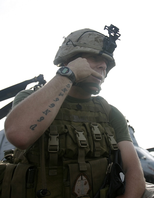 Staff Sergeant Kyle Bujno, platoon sergeant, Company E, Battalion Landing Team 2/2, demonstrates how to call in a casualty aboard USS Bataan, March 28.  The Marines and Sailors of E Co. were practicing patrolling and evacuation drills to increase the chances of a casualty's survival if one were to occur in combat.  Photo by Staff Sgt. Trent Kinsey