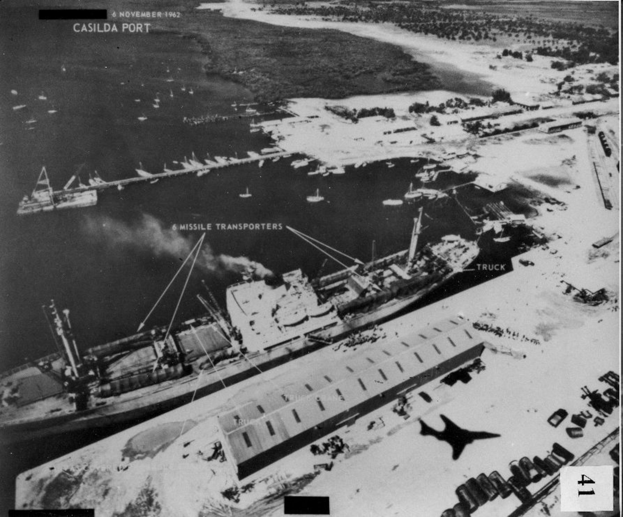 Port Casilda, Cuba, is captured by an RF-101 pilot with the 363rd Tactical Reconnaissance Wing on Nov. 6, 1962, while the aircraft itself casts a shadow over the port. The 363rd, activated once again March 26 as a training group on an air base in the Persian Gulf region, has a long and notable history, to include the 363rd TRW, which performed actions in association with the Cuban Missile Crisis. (U.S. Air Force photo)