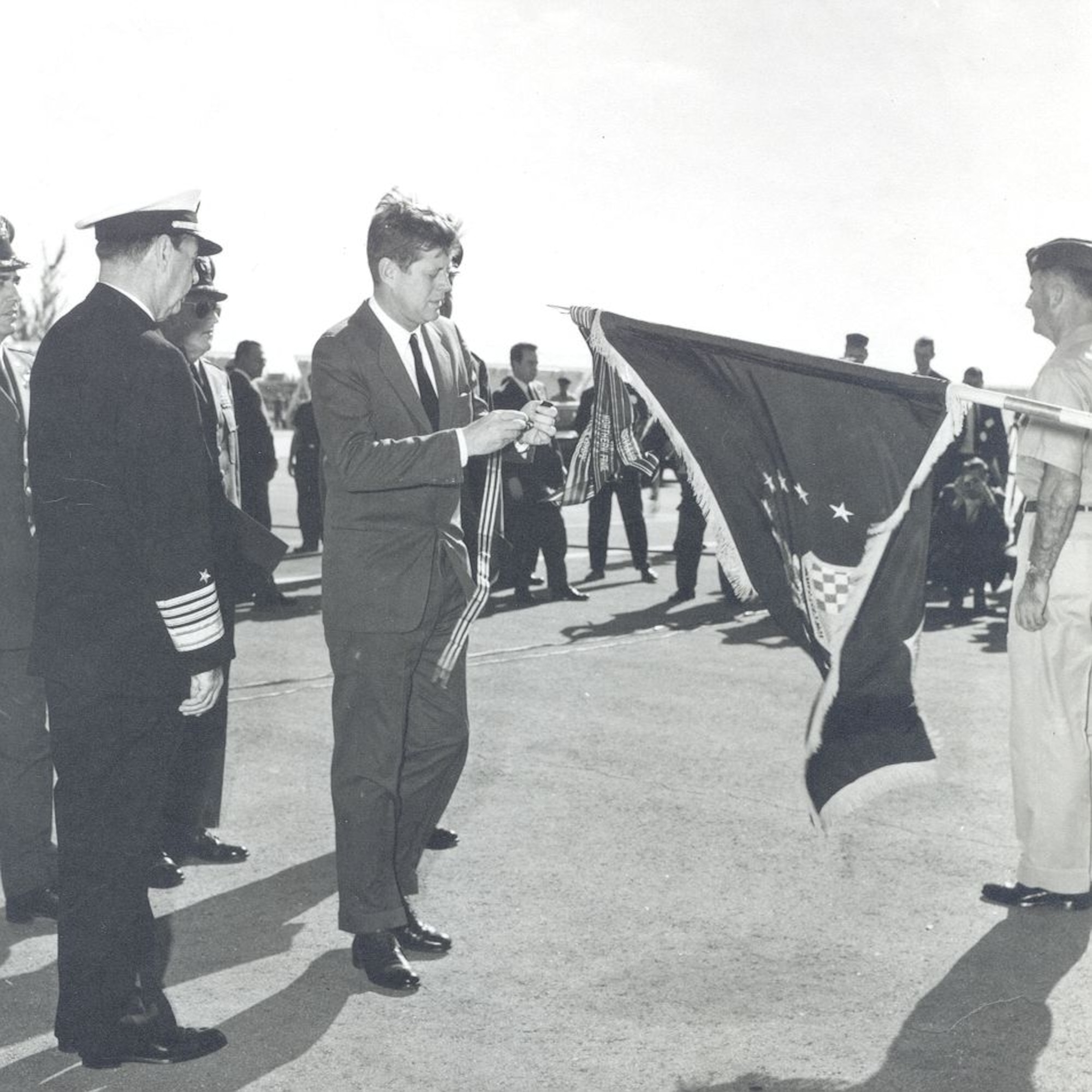 President John F. Kennedy places a streamer on the colors of the 363rd Tactical Reconnaissance Wing to present the Air Force Outstanding Unit Award in recognition of the unit's actions associated with the Cuban Missile Crisis. The 363rd, activated once again March 26 as a training group on an air base in the Persian Gulf region, follows in the historic footsteps of the 363rd TRW. (U.S. Air Force photo)
